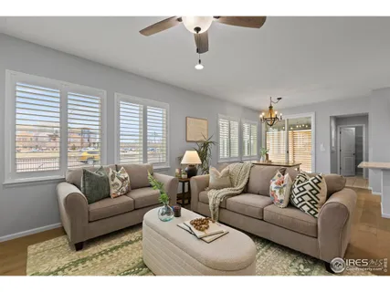 a living room with furniture and a view of kitchen