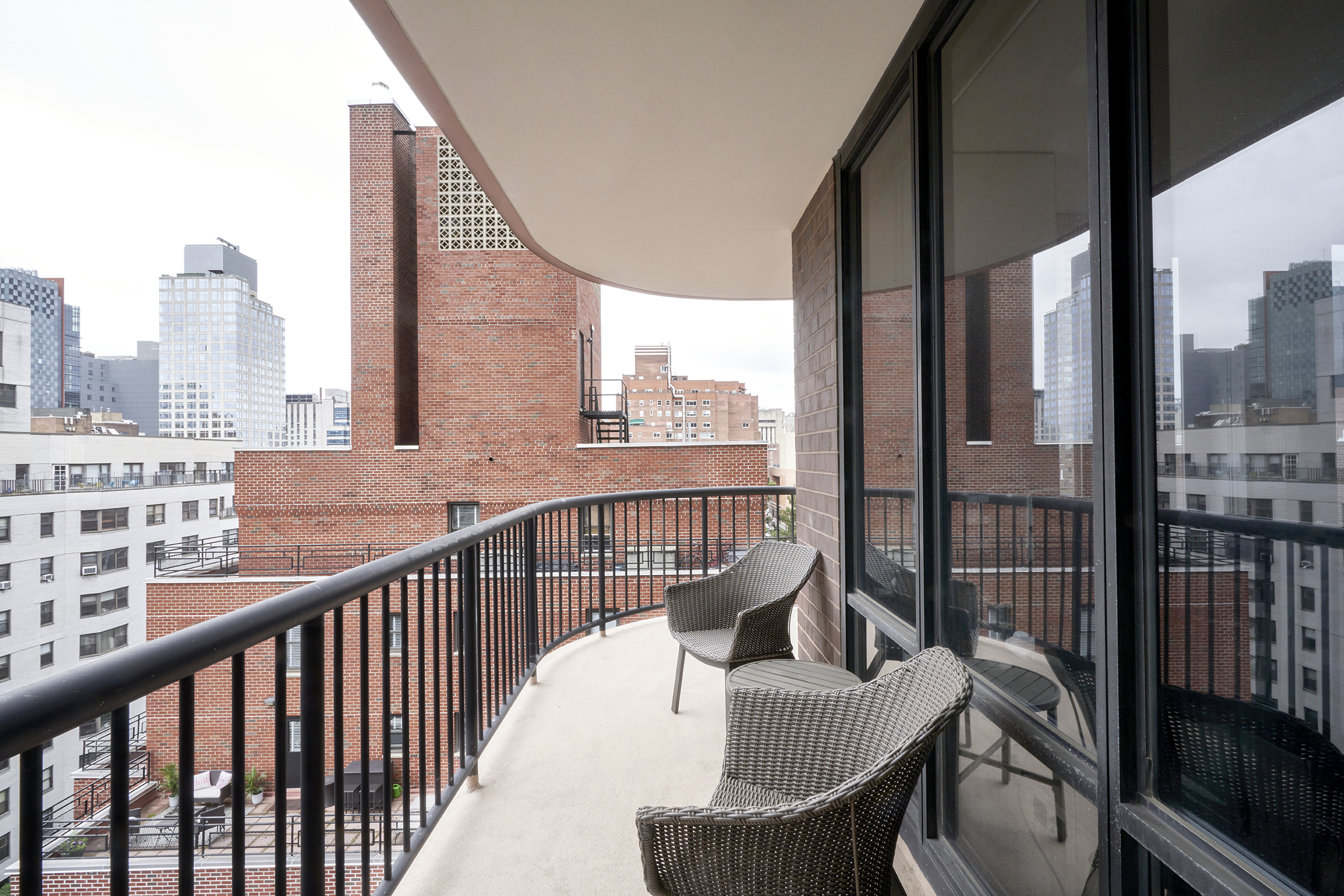 304 East 65th Street, Unit 12D Manhattan, NY 10065 - Photo 5 of 6 a view of a balcony with a couch
