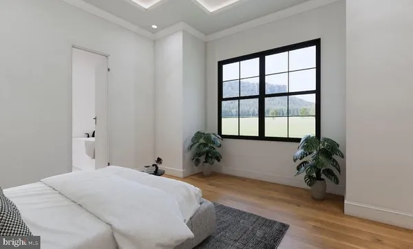 a bedroom with a bed and a potted plant