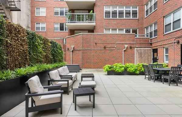 a view of a patio with couple of chairs