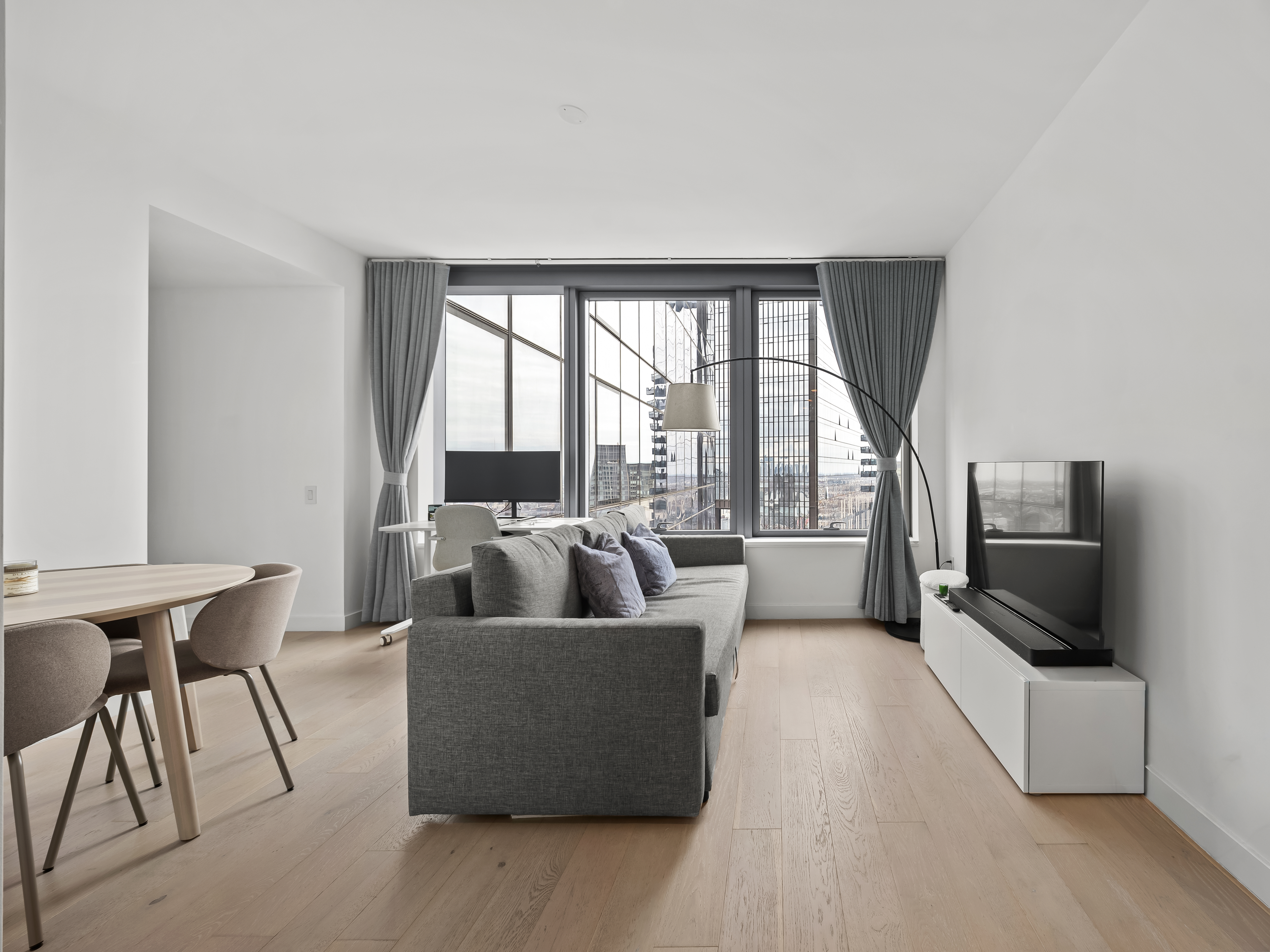 45-3 Court Square, Unit 4406 Queens, NY 11101 - Photo 1 of 22 a living room with furniture and a flat screen tv