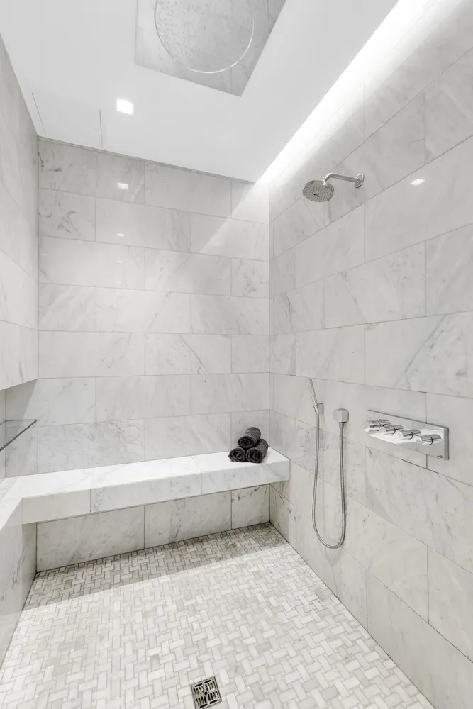 a bathroom with a sink a toilet and a shower