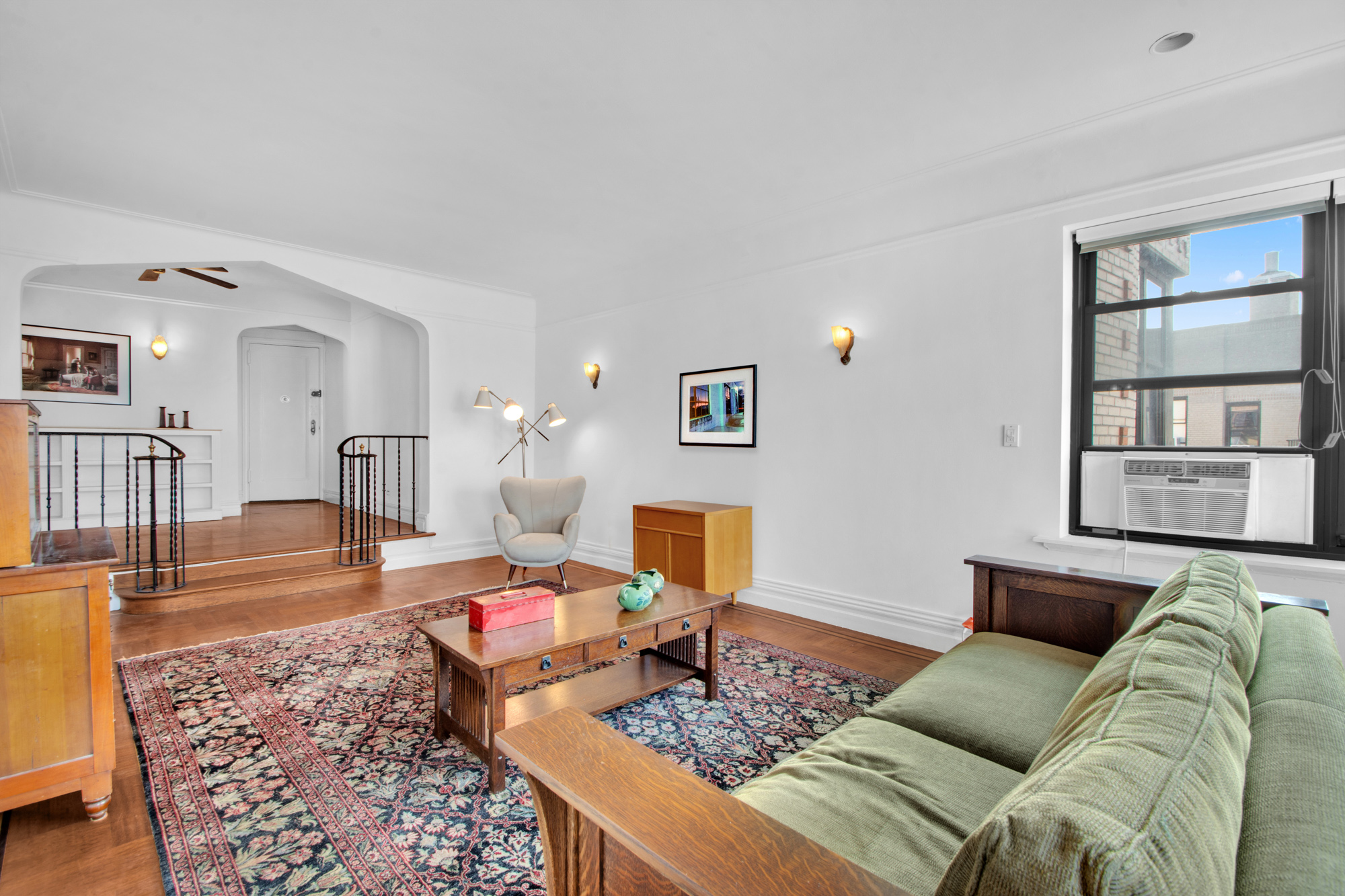 200 Pinehurst Avenue, Unit 5C Manhattan, NY 10033 - Photo 4 of 17 a living room with furniture and wooden floor