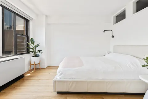 a bedroom with a bed and window