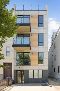 a front view of a building with a garden