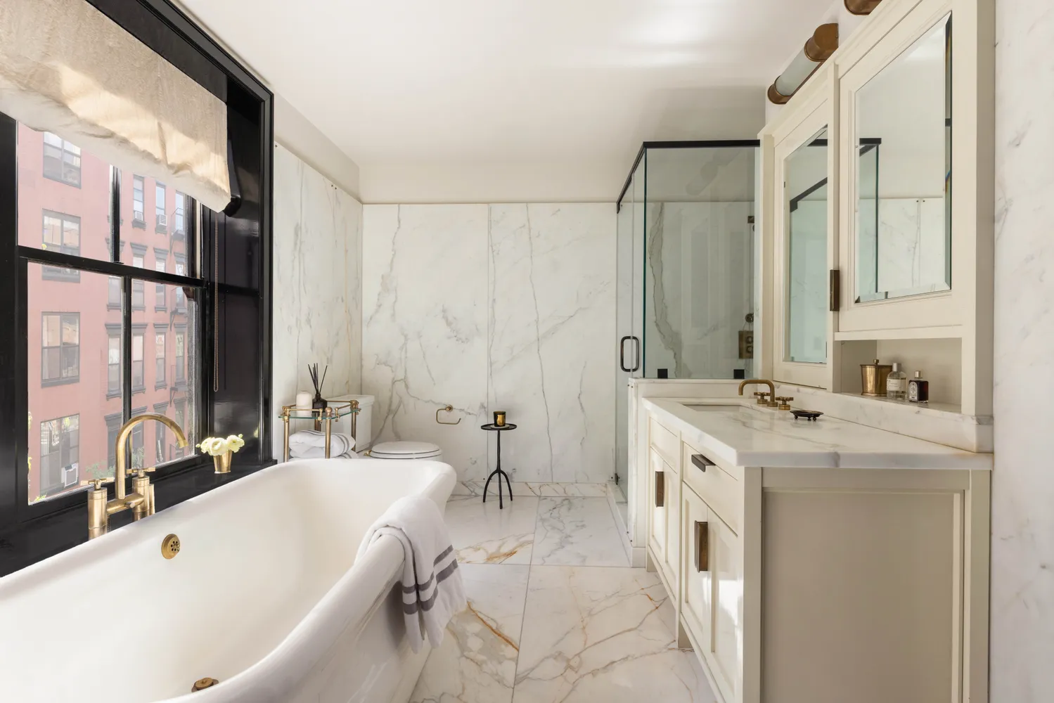 a bathroom with a tub sink and mirror