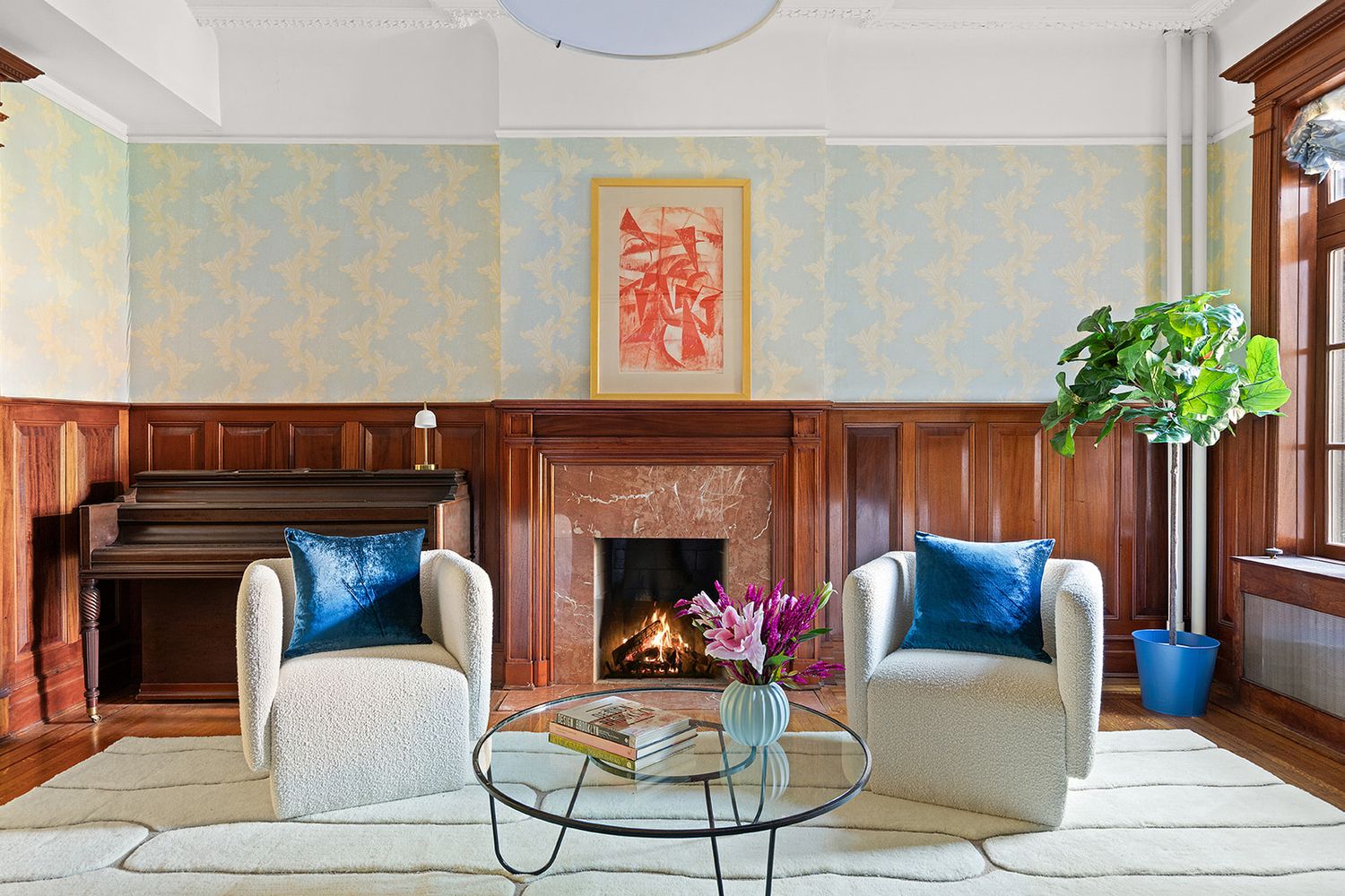 a living room with furniture potted plant and a fireplace