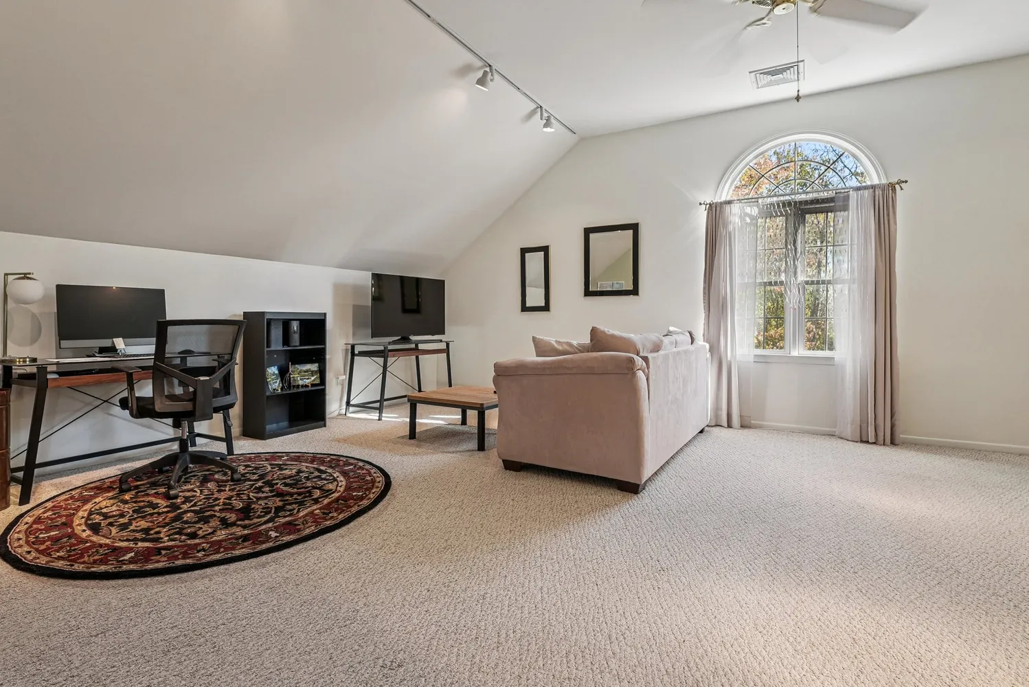 a living room with furniture and a chandelier