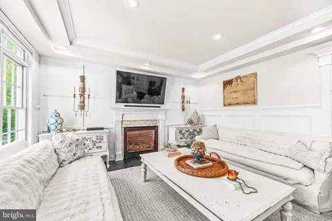 a large kitchen with kitchen island a large window a sink stainless steel appliances and cabinets