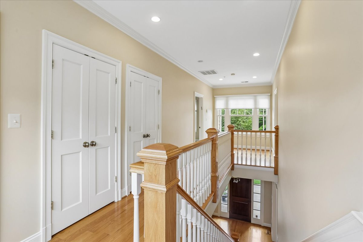 11736 Gainsborough Road Potomac, MD 20854 - Photo 61 of 90 a view of a hallway with wooden floor and stairs