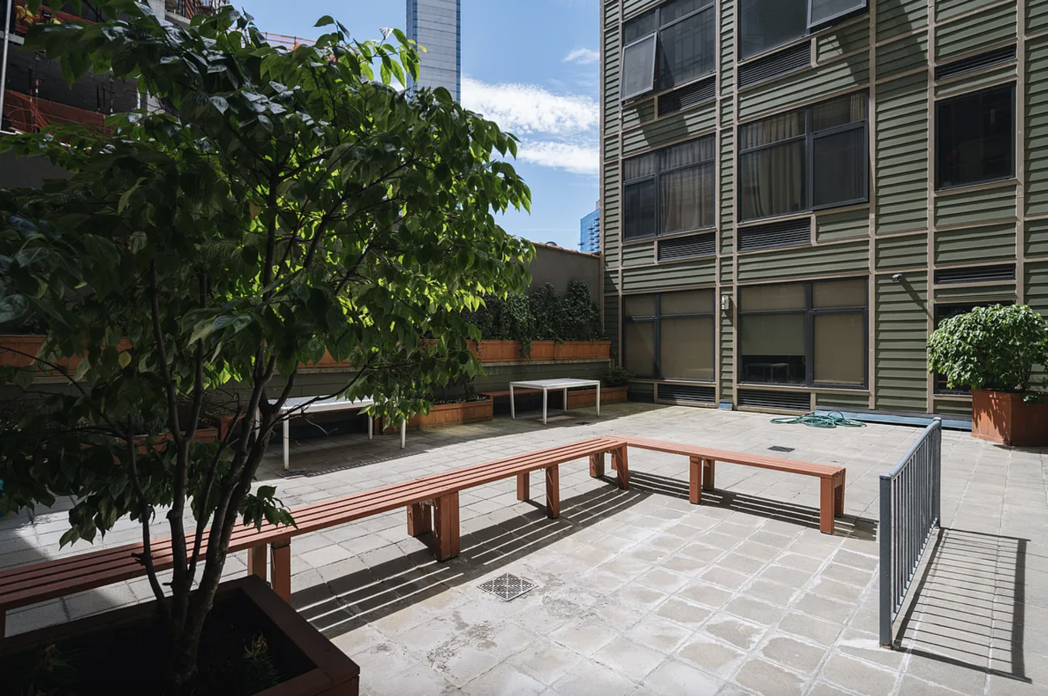 42-37 27th Street, Unit 8B Queens, NY 11101 - Photo 9 of 11 a view of a balcony with chairs and a potted plant