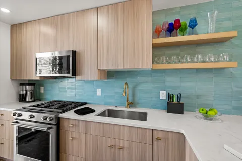 a kitchen with stainless steel appliances a stove a sink and a cabinets
