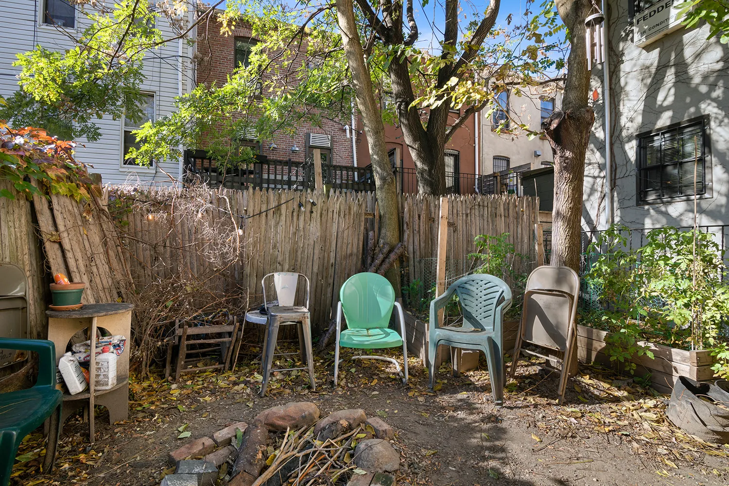 a backyard of a house with barbeque oven table and chairs