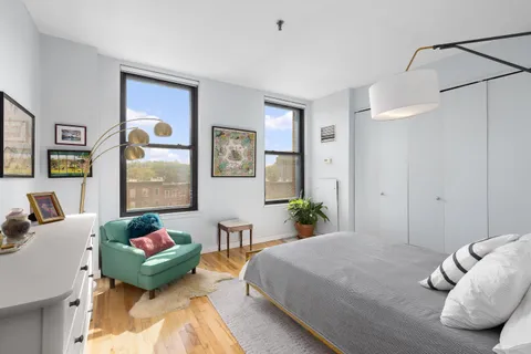 a bedroom with a bed and a couch