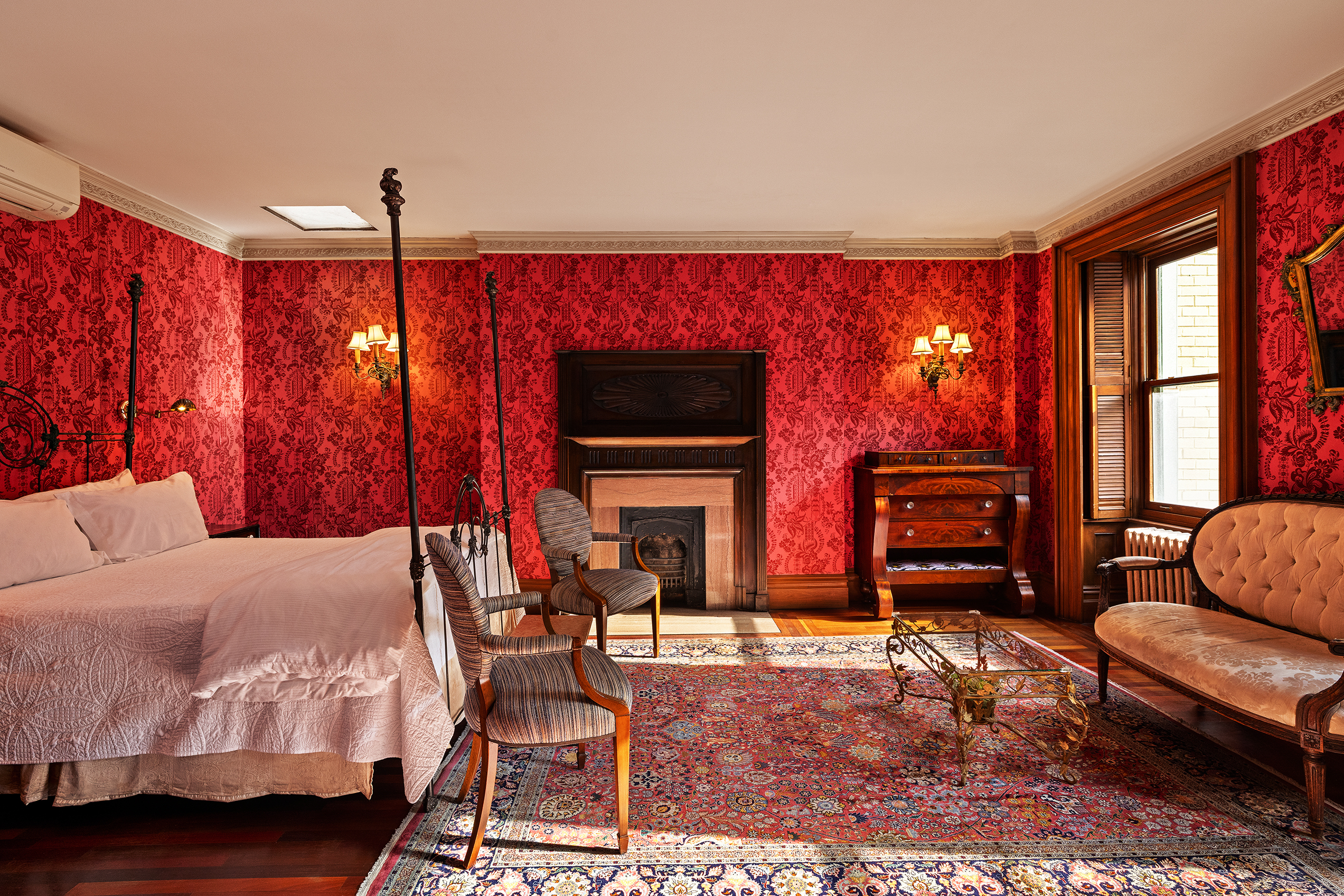 a bedroom with furniture a flat screen tv and a fireplace