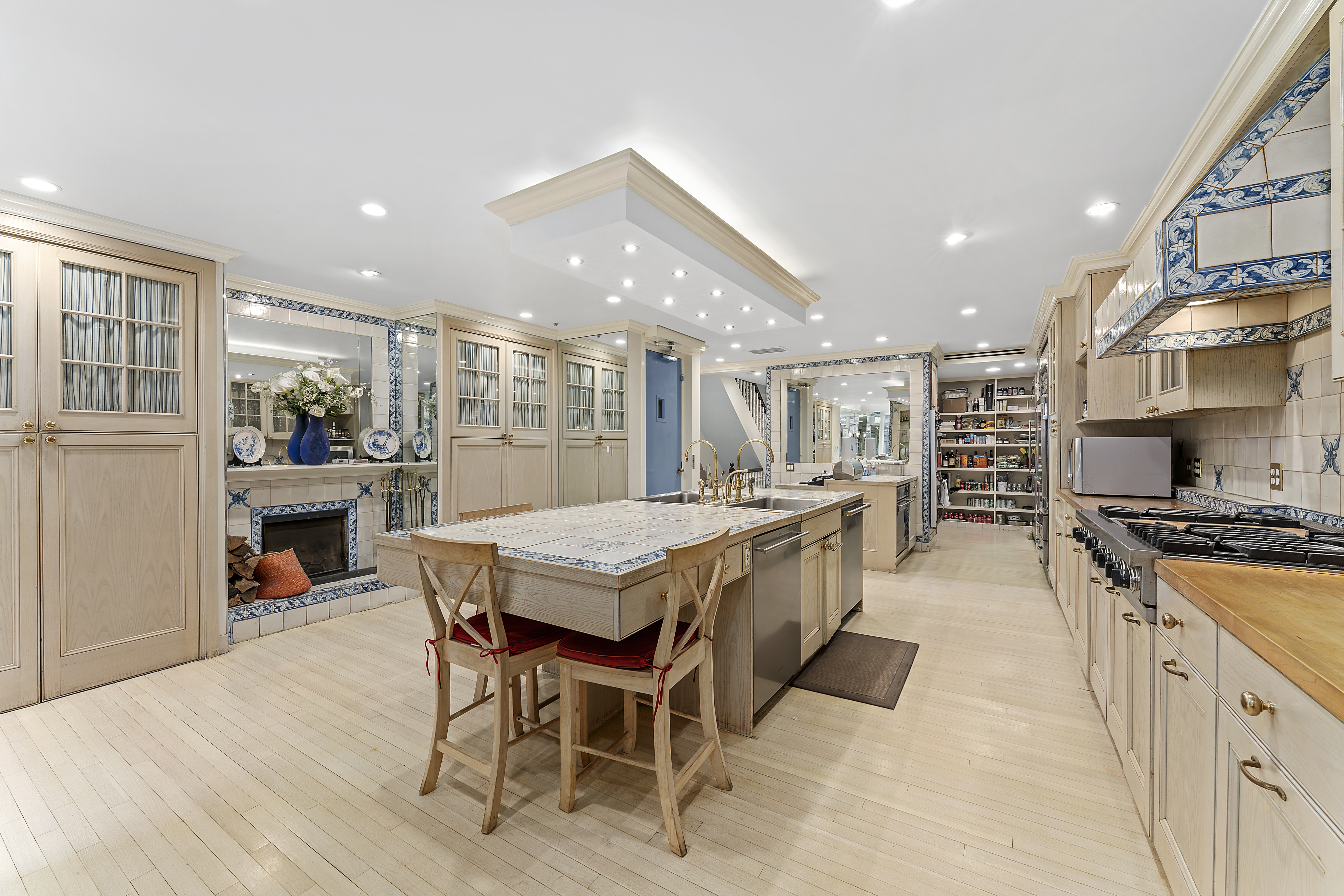 21 West 70th Street Manhattan, NY 10023 - Photo 9 of 12 a large kitchen with a table and chairs in it