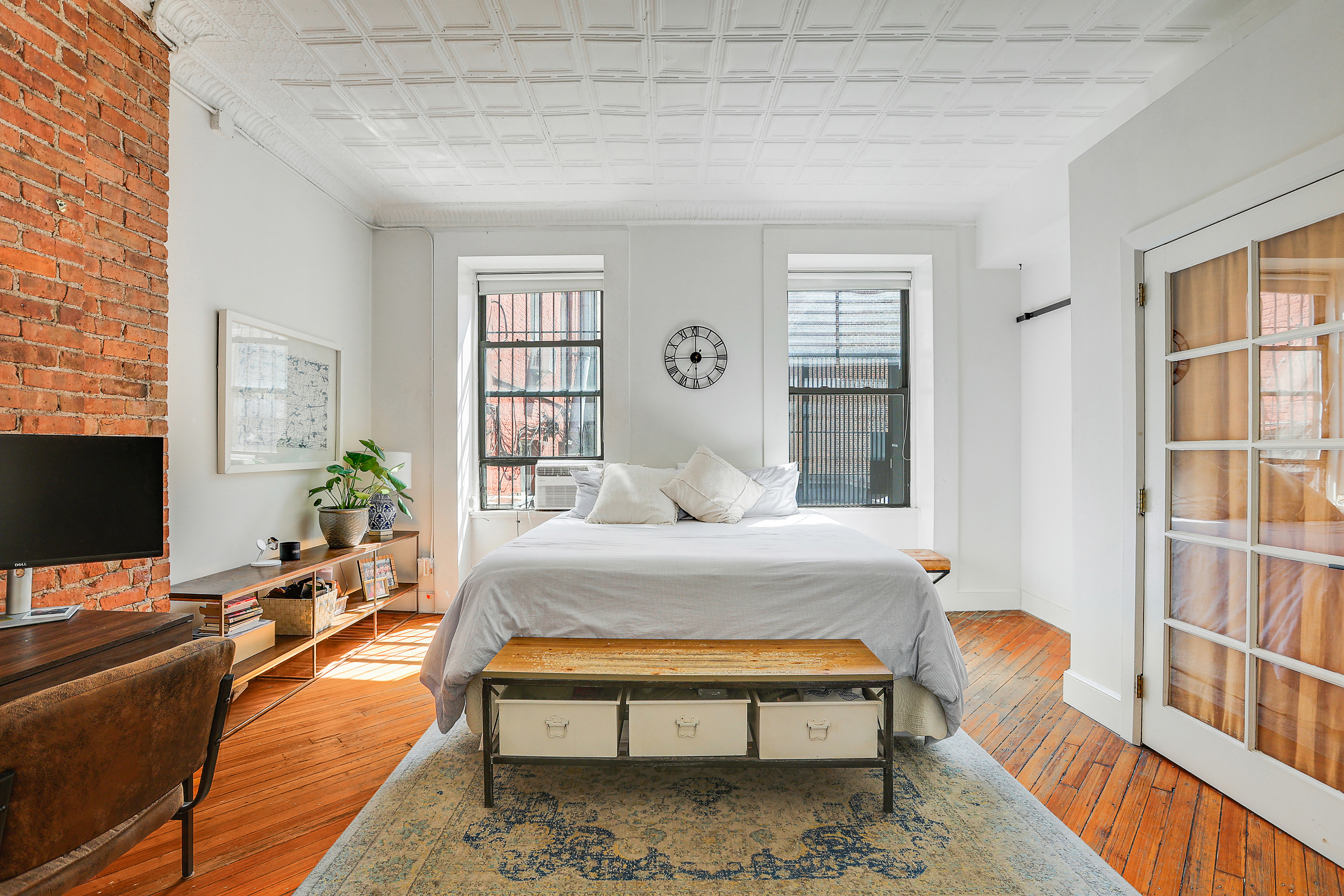 5 Great Jones Street Manhattan, NY 10012 - Photo 5 of 11 a bedroom with furniture and a window