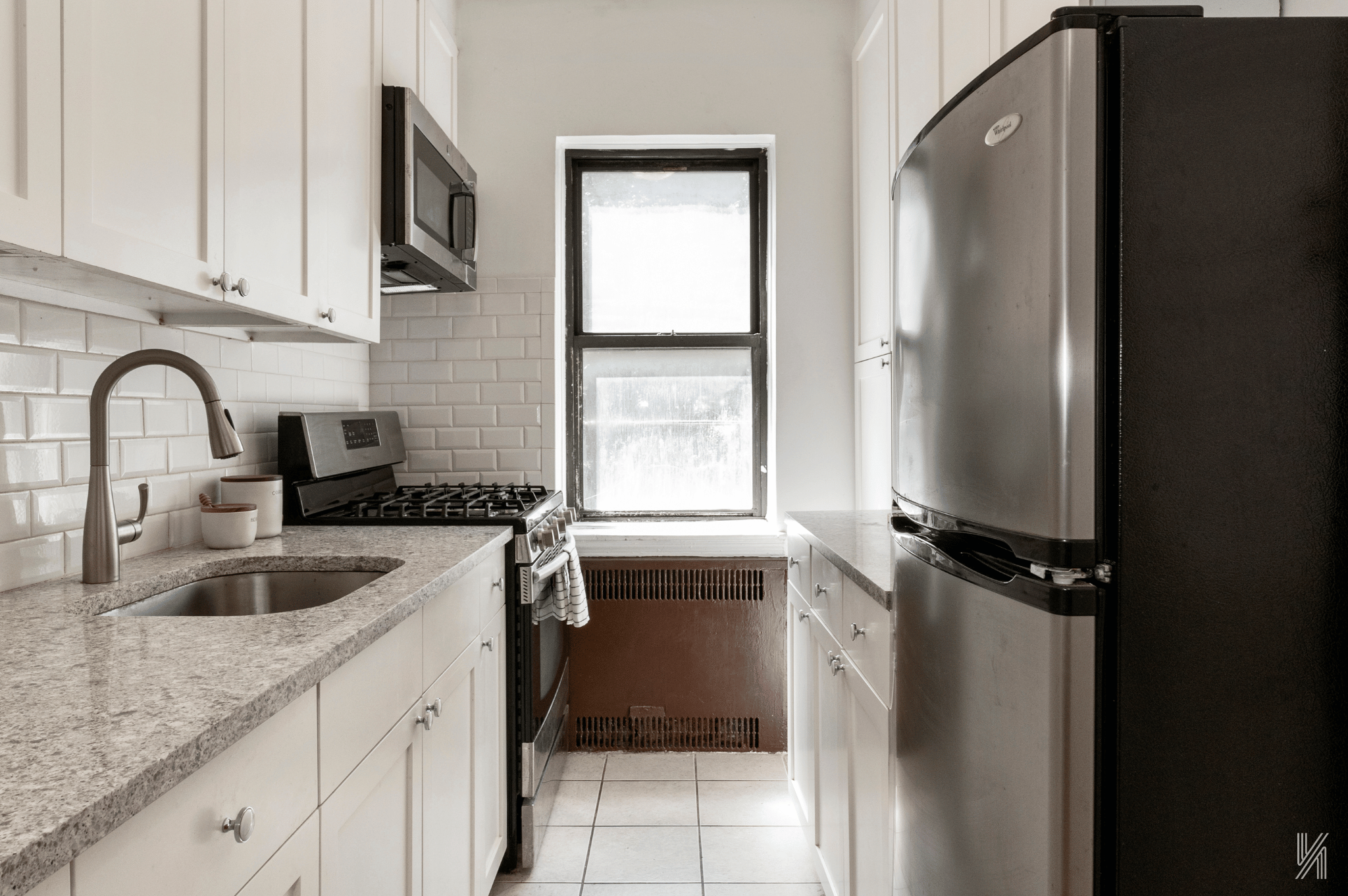 35-35 75th Street, Unit 428 Queens, NY 11372 - Photo 11 of 21 a kitchen with a refrigerator and a sink