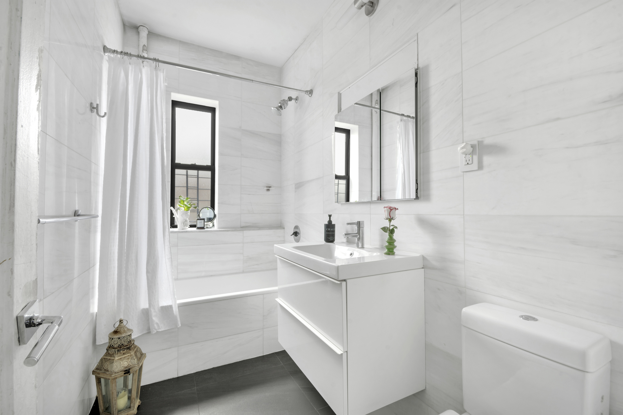 47 Fort Washington Avenue, Unit 61 Manhattan, NY 10032 - Photo 9 of 14 a bathroom with a sink a toilet and shower
