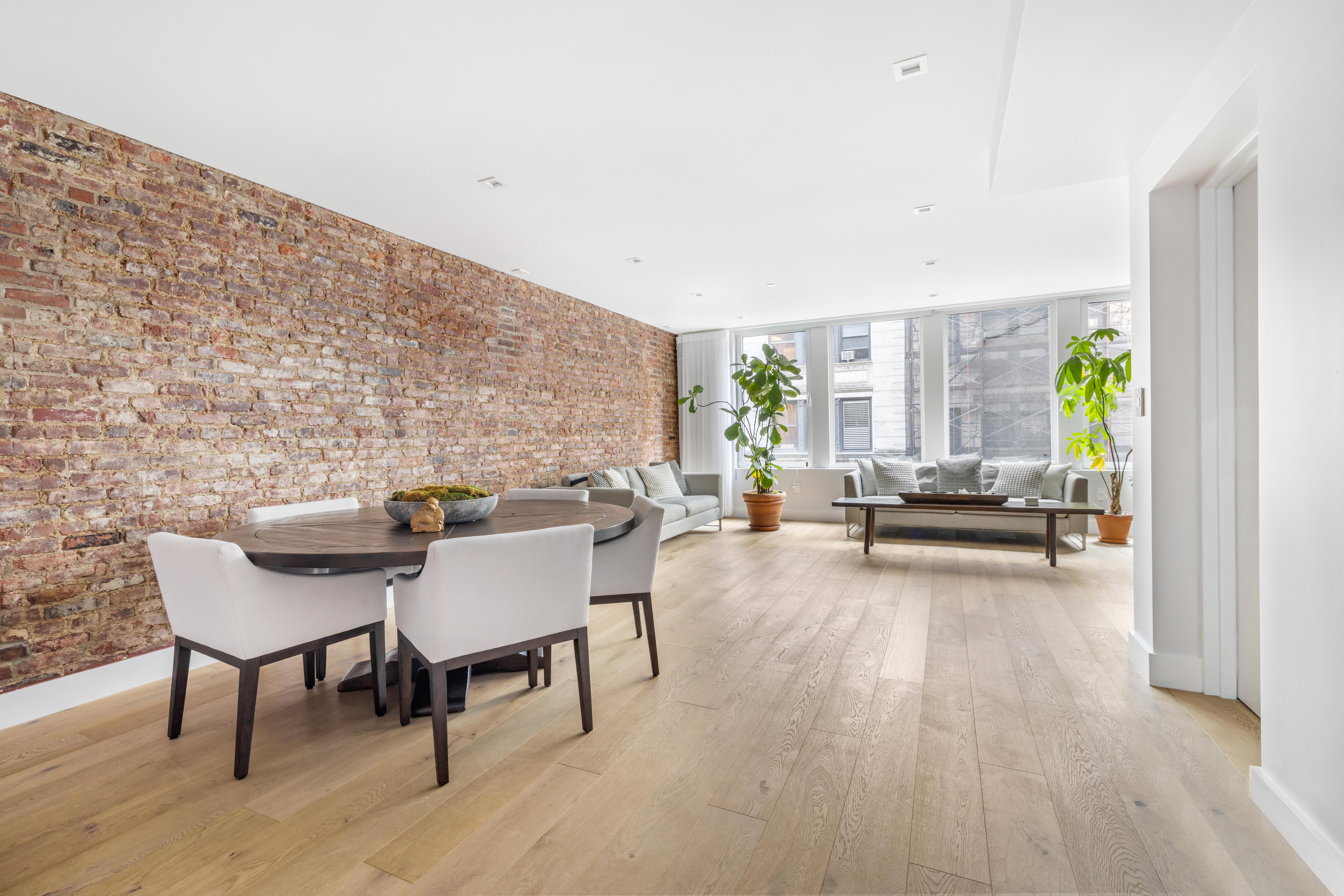 17 East 17th Street, Unit 4 Manhattan, NY 10003 - Photo 2 of 11 a living room with furniture and a wooden floor