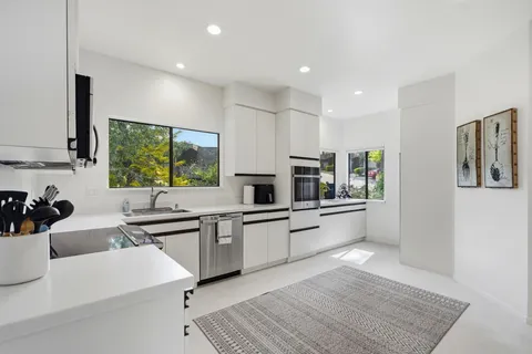 a kitchen with a sink cabinets and window