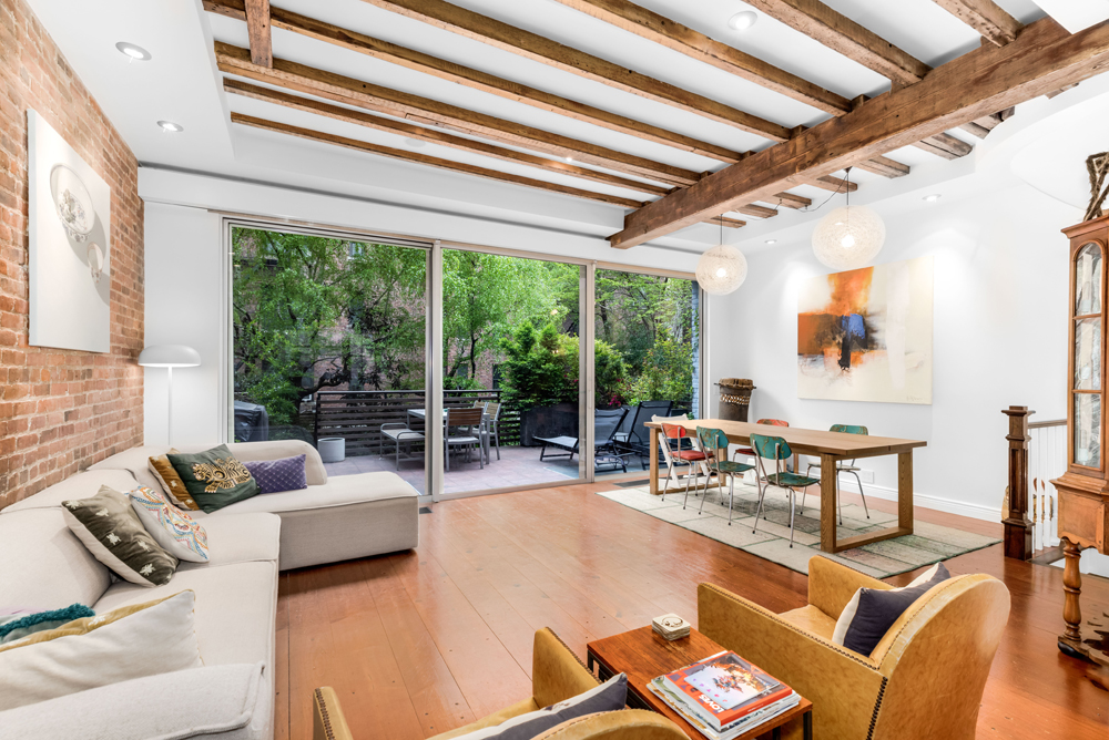 308 West 19th Street, Unit GARDEN Manhattan, NY 10011 - Photo 3 of 18 a living room with furniture and a large window