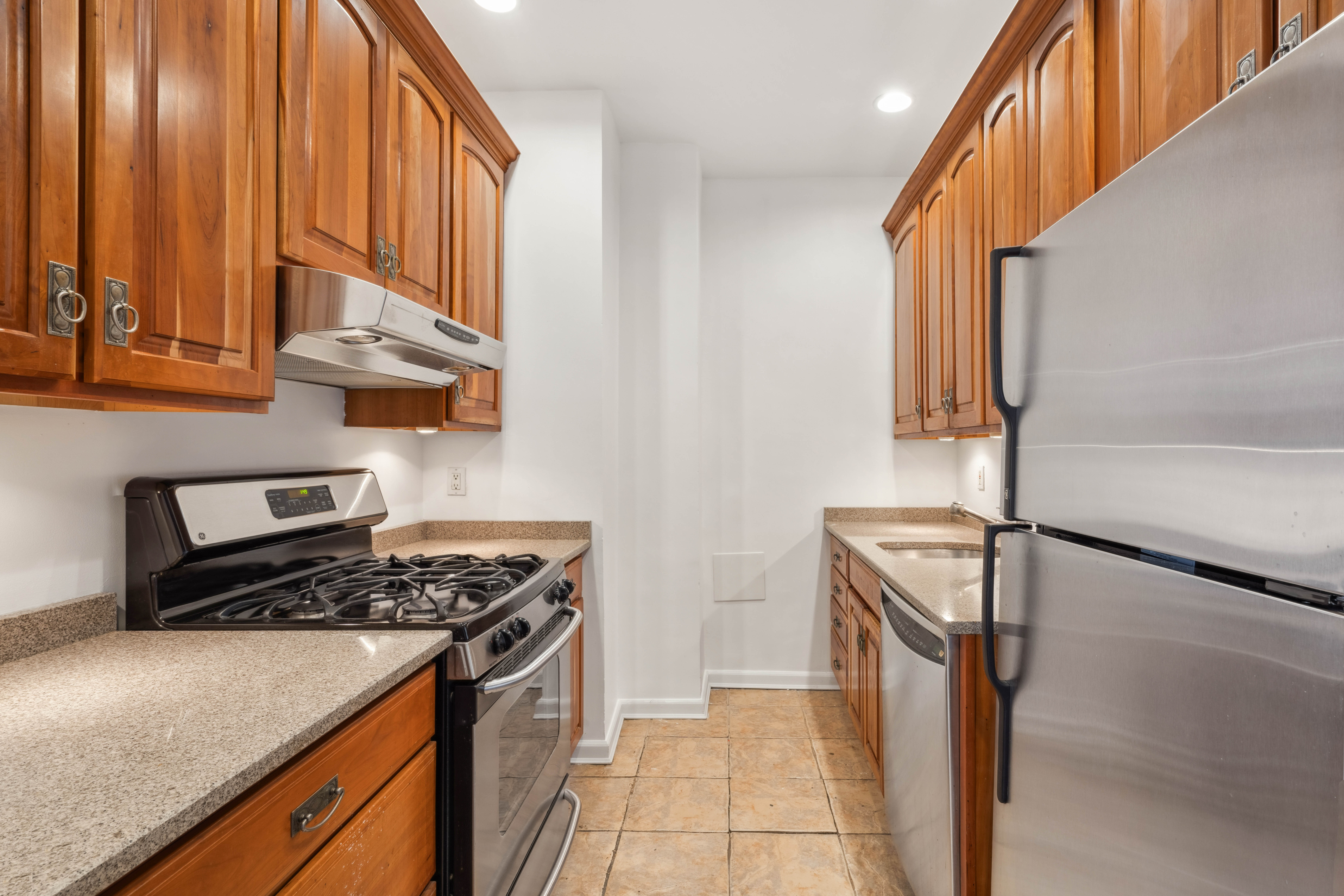 380 Riverside Drive, Unit 7B Manhattan, NY 10025 - Photo 4 of 12 a kitchen with stainless steel appliances granite countertop a stove a sink and a microwave