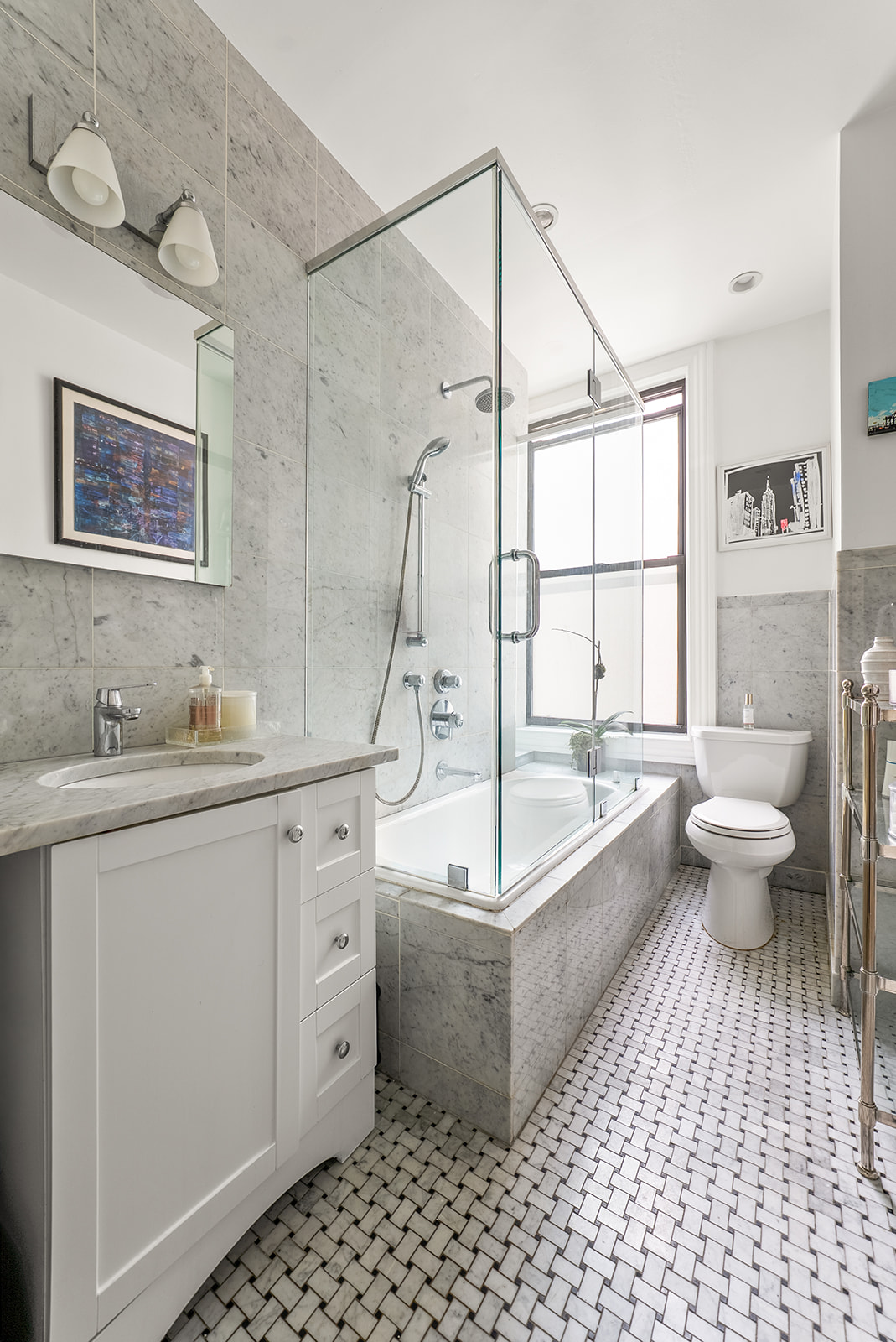 200 West 54th Street, Unit 10D Manhattan, NY 10019 - Photo 6 of 8 a spacious bathroom with a double vanity sink a mirror and a bathtub