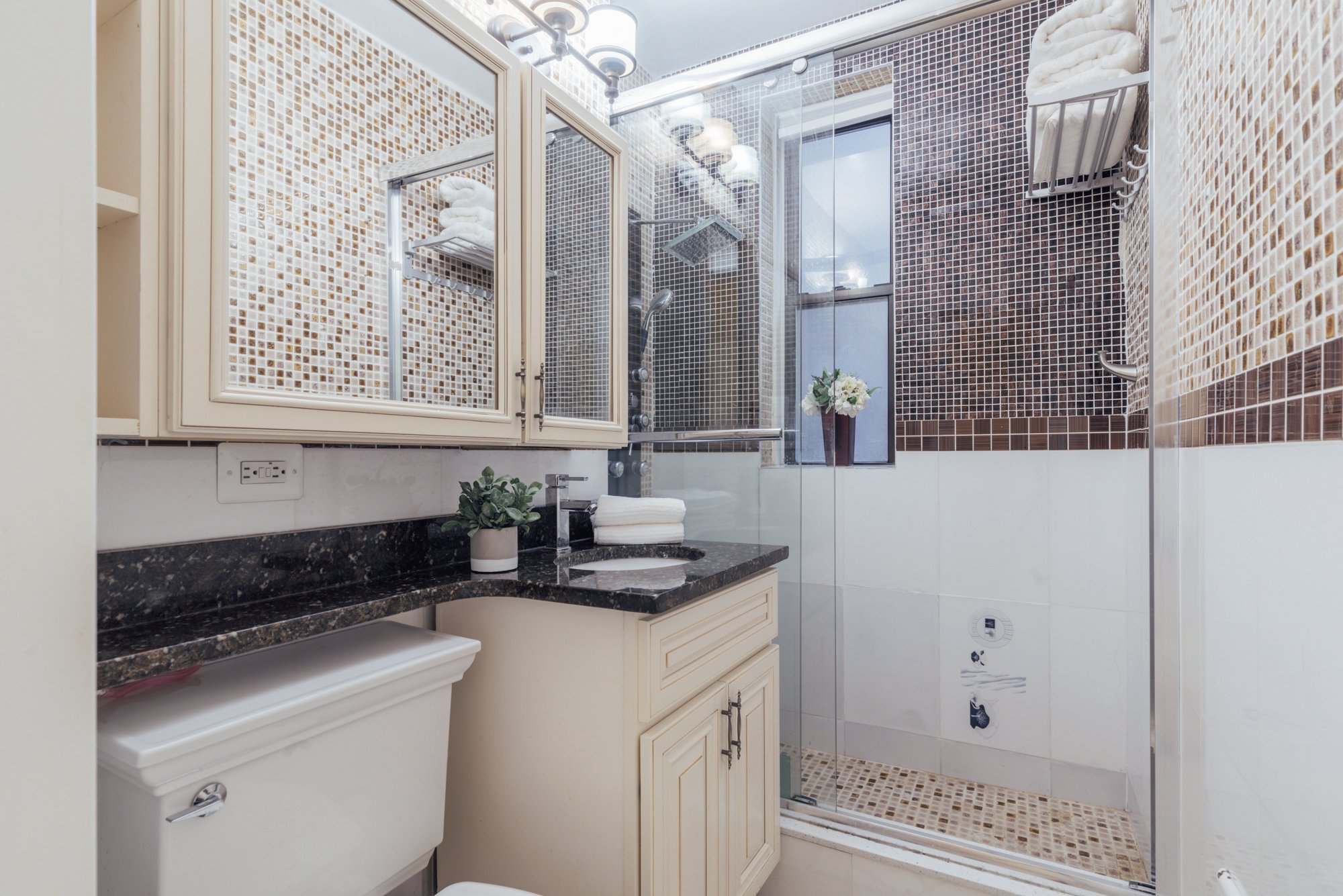 162 West 56th Street, Unit 1102 Manhattan, NY 10019 - Photo 6 of 12 a kitchen with a sink and cabinets