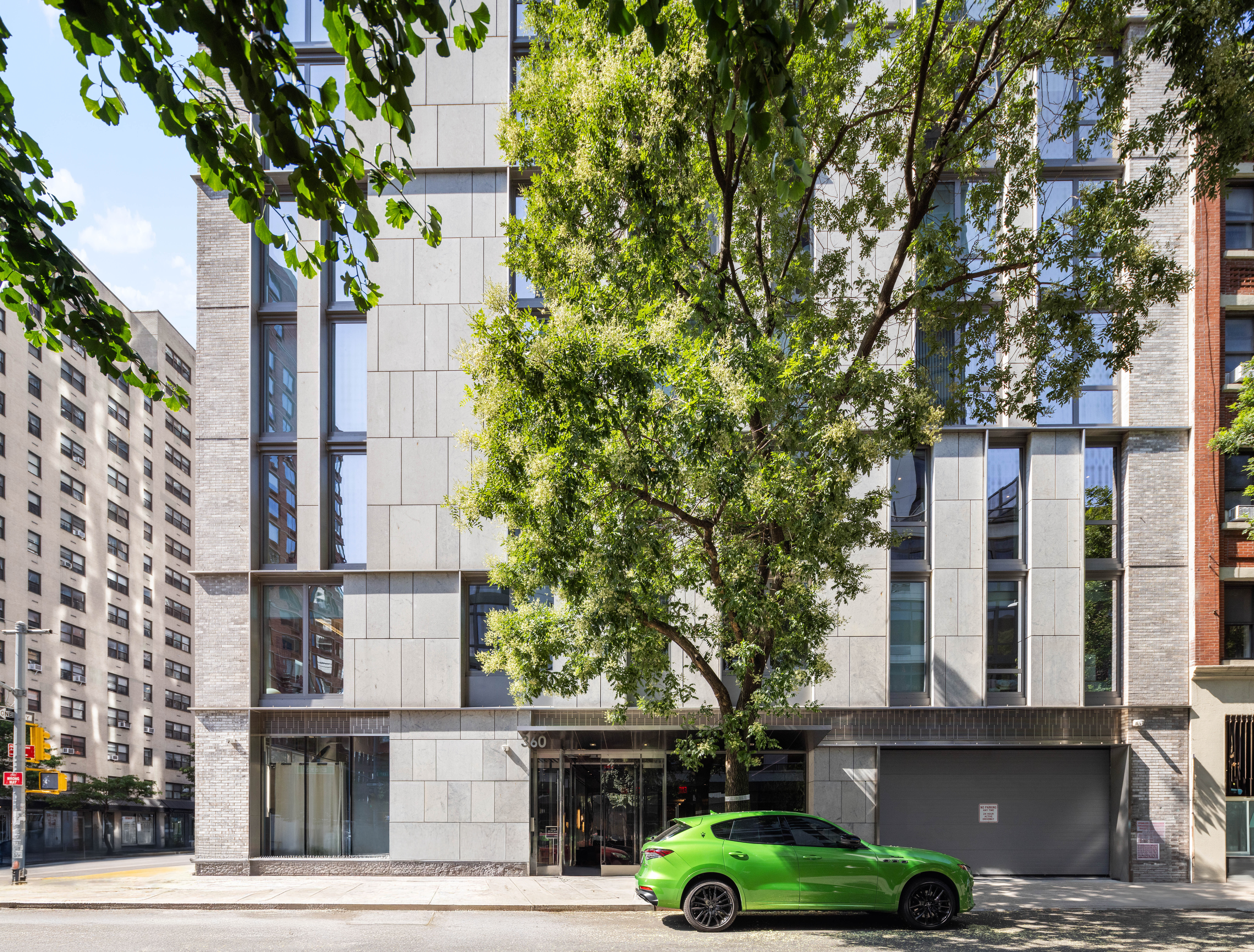 360 East 89th Street, Unit 5D Manhattan, NY 10128 - Photo 12 of 13 front view of a building with a tree