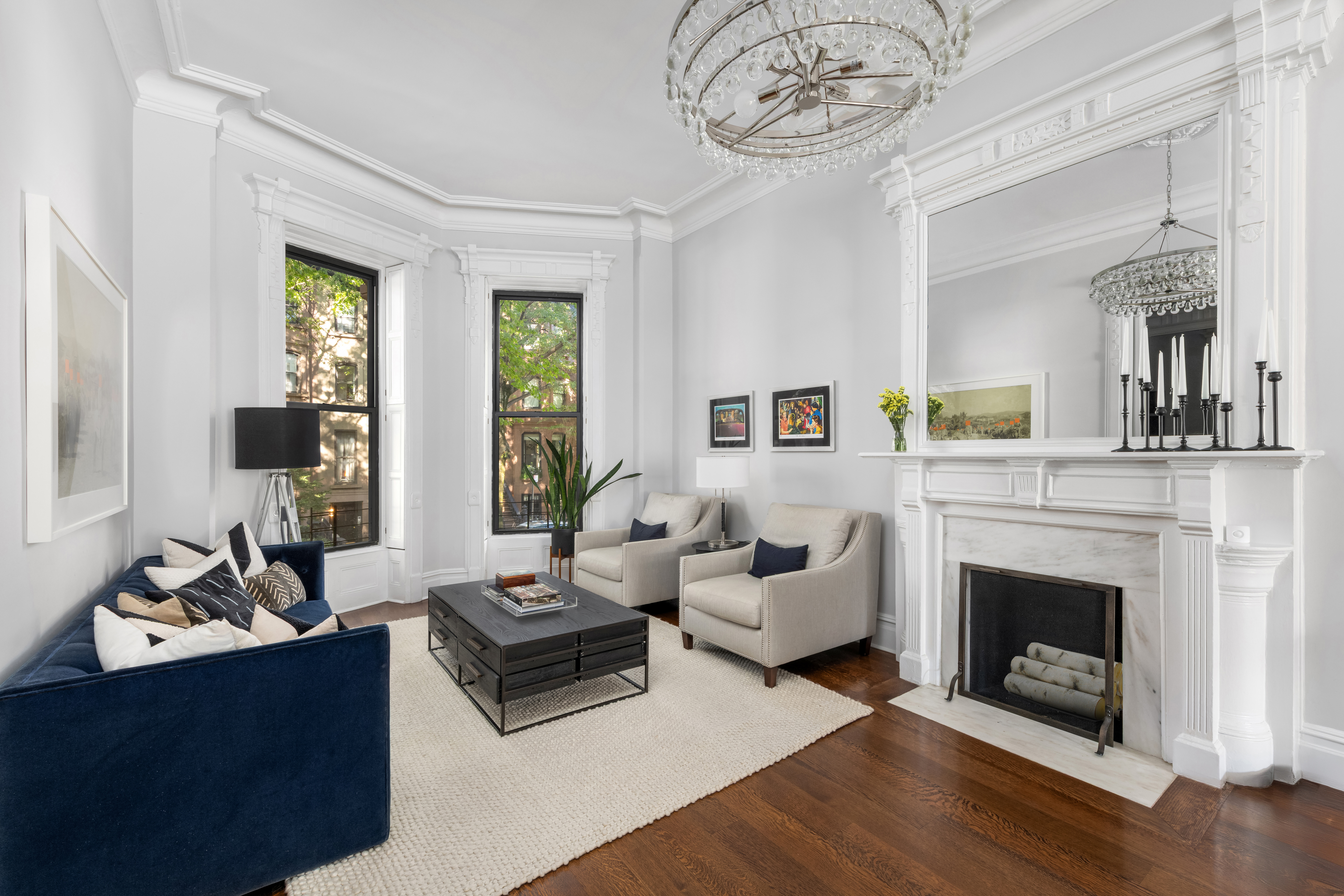 159 6th Avenue, Unit TRIPLEX Brooklyn, NY 11217 - Photo 1 of 19 a living room with furniture a fireplace and a table