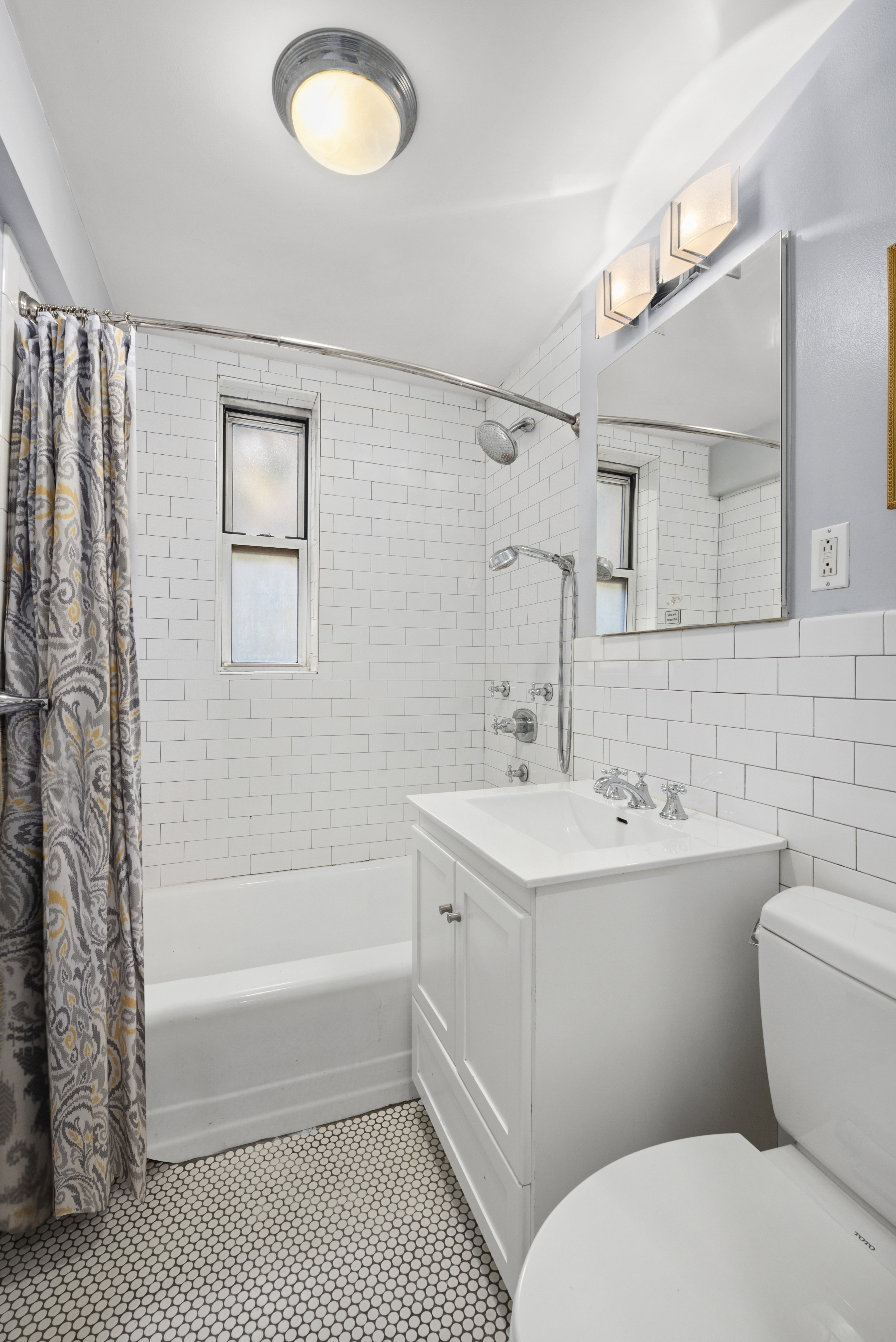 302 East 88th Street, Unit 2G Manhattan, NY 10128 - Photo 14 of 16 a bathroom with a sink toilet and shower