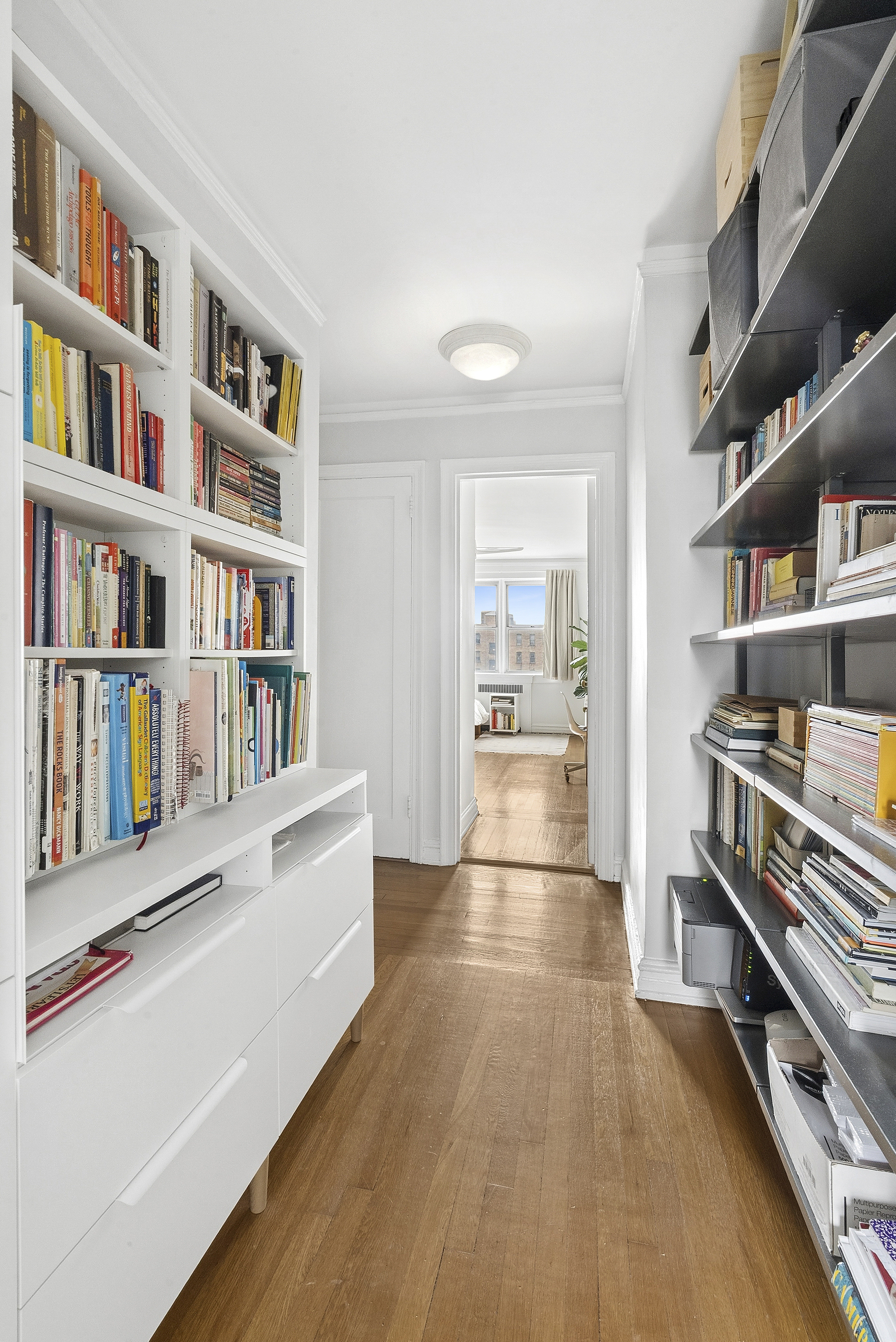 474 West 238th Street, Unit 2E Bronx, NY 10463 - Photo 8 of 13 a view of a living room with lots of books