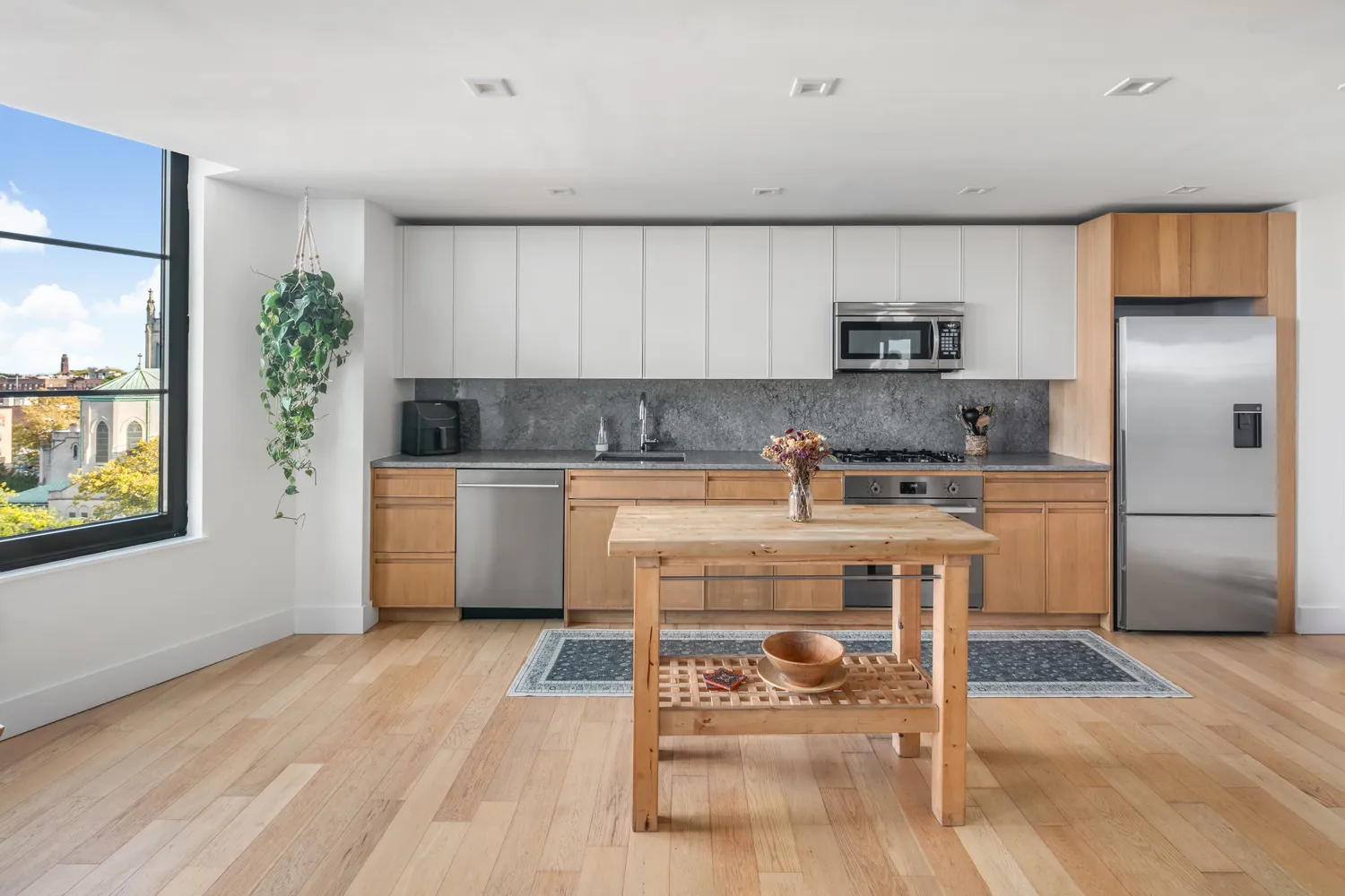a kitchen with a white cabinets and chairs in it