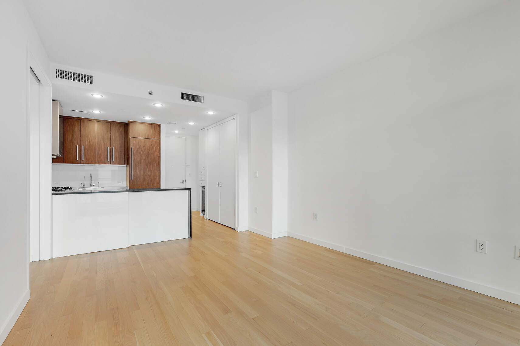 133 West 22nd Street, Unit 7H Manhattan, NY 10011 - Photo 4 of 21 a view of kitchen with kitchen island and stainless steel appliances