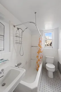 a bathroom with a sink a toilet and shower curtain