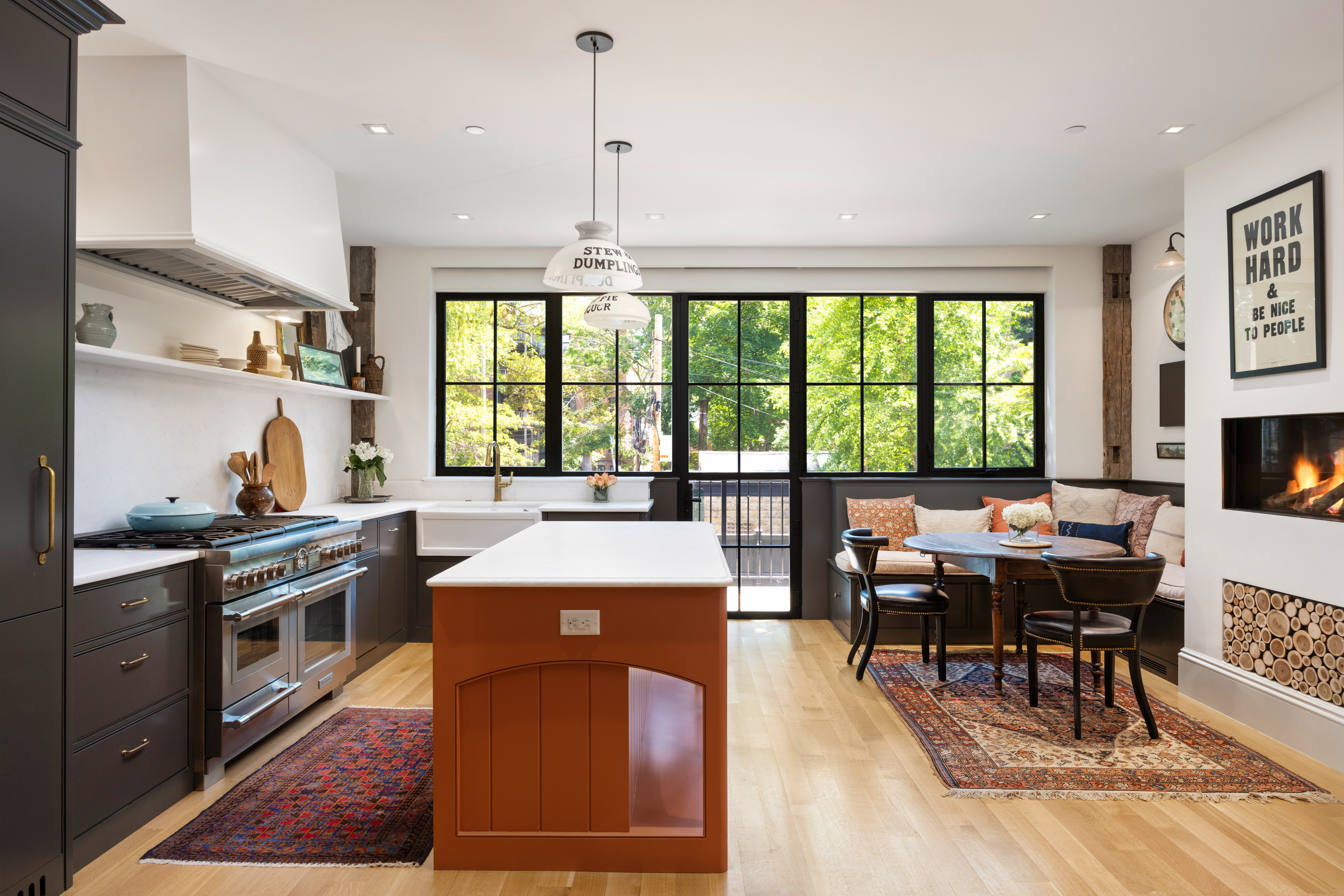 South End Boston, MA 02118 - Photo 2 of 24 a open kitchen with stainless steel appliances granite countertop a stove top oven a sink a dining table and chairs with wooden floor