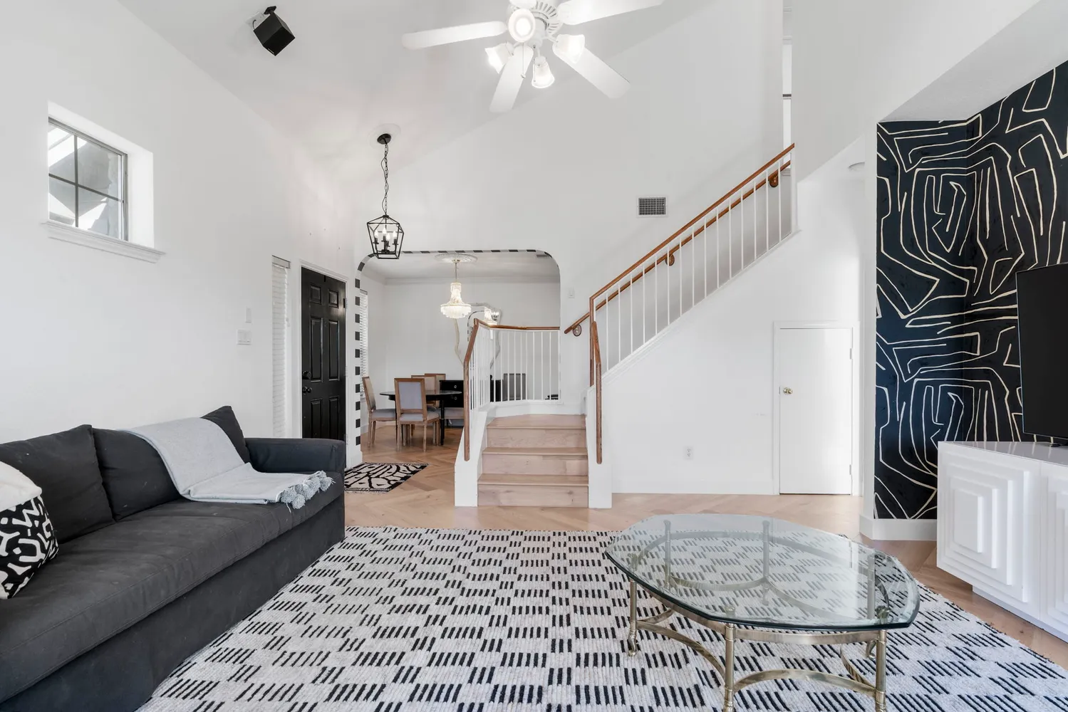 a living room with furniture and wooden floor