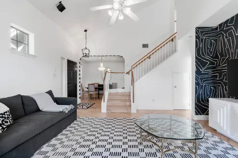 a living room with furniture and wooden floor