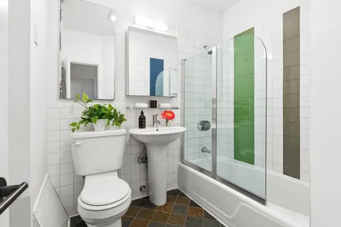 a bathroom with a sink toilet and shower