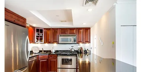 a kitchen with stainless steel appliances granite countertop a refrigerator a stove top oven a sink and dishwasher