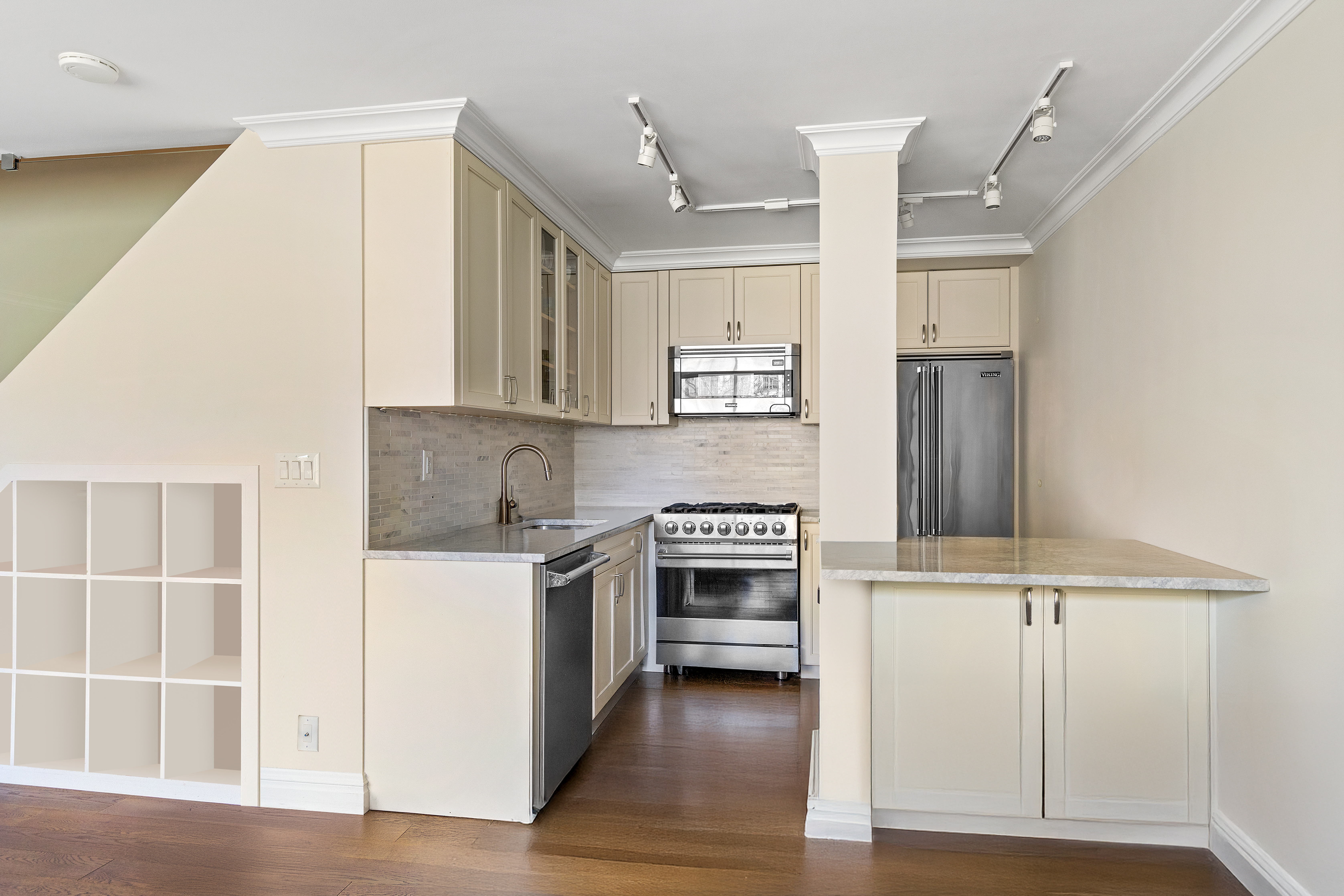 551 Main Street, Unit 208 Manhattan, NY 10044 - Photo 18 of 36 a kitchen with cabinets and wooden floor