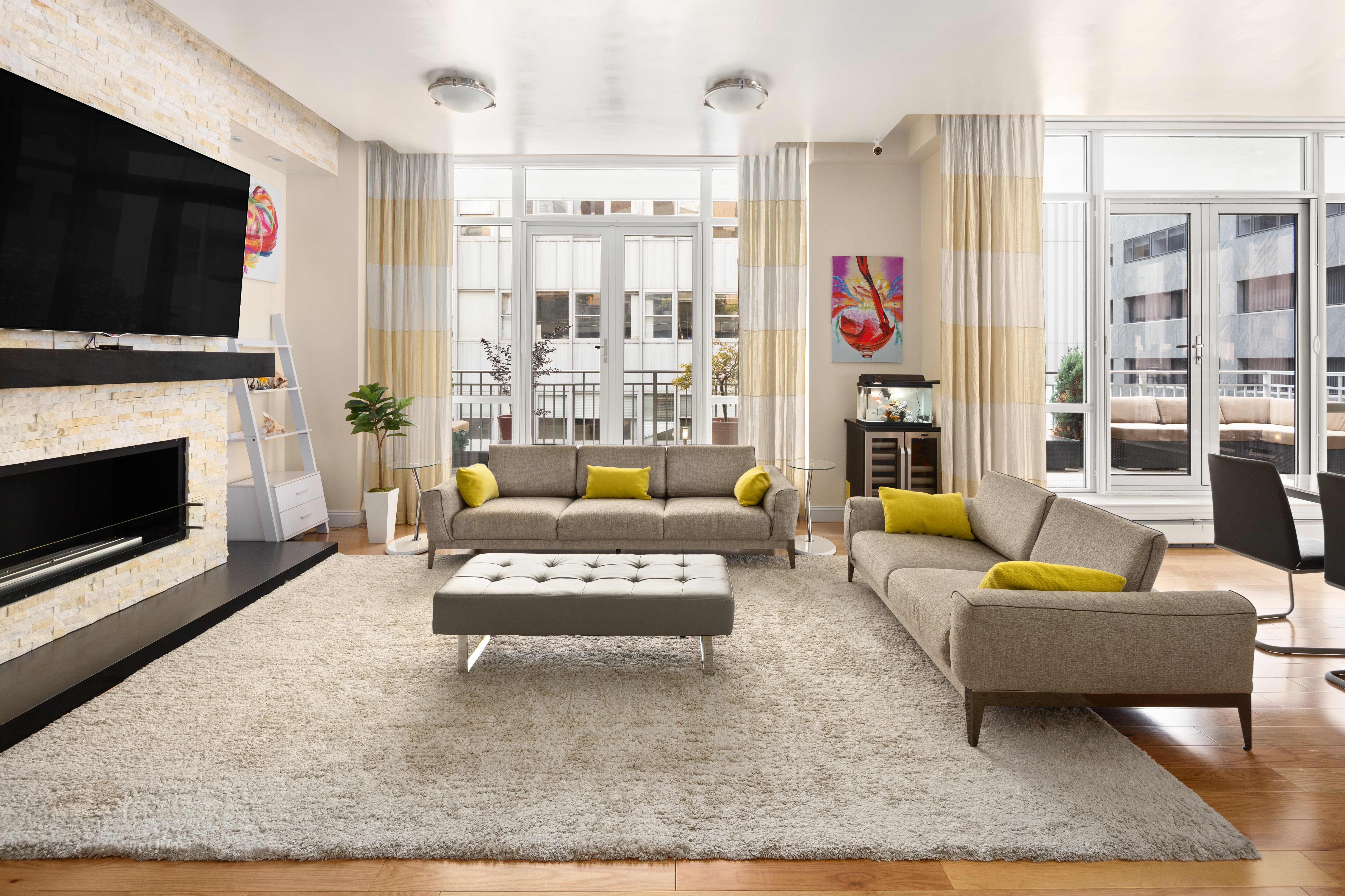 a living room with furniture a flat screen tv and a fireplace