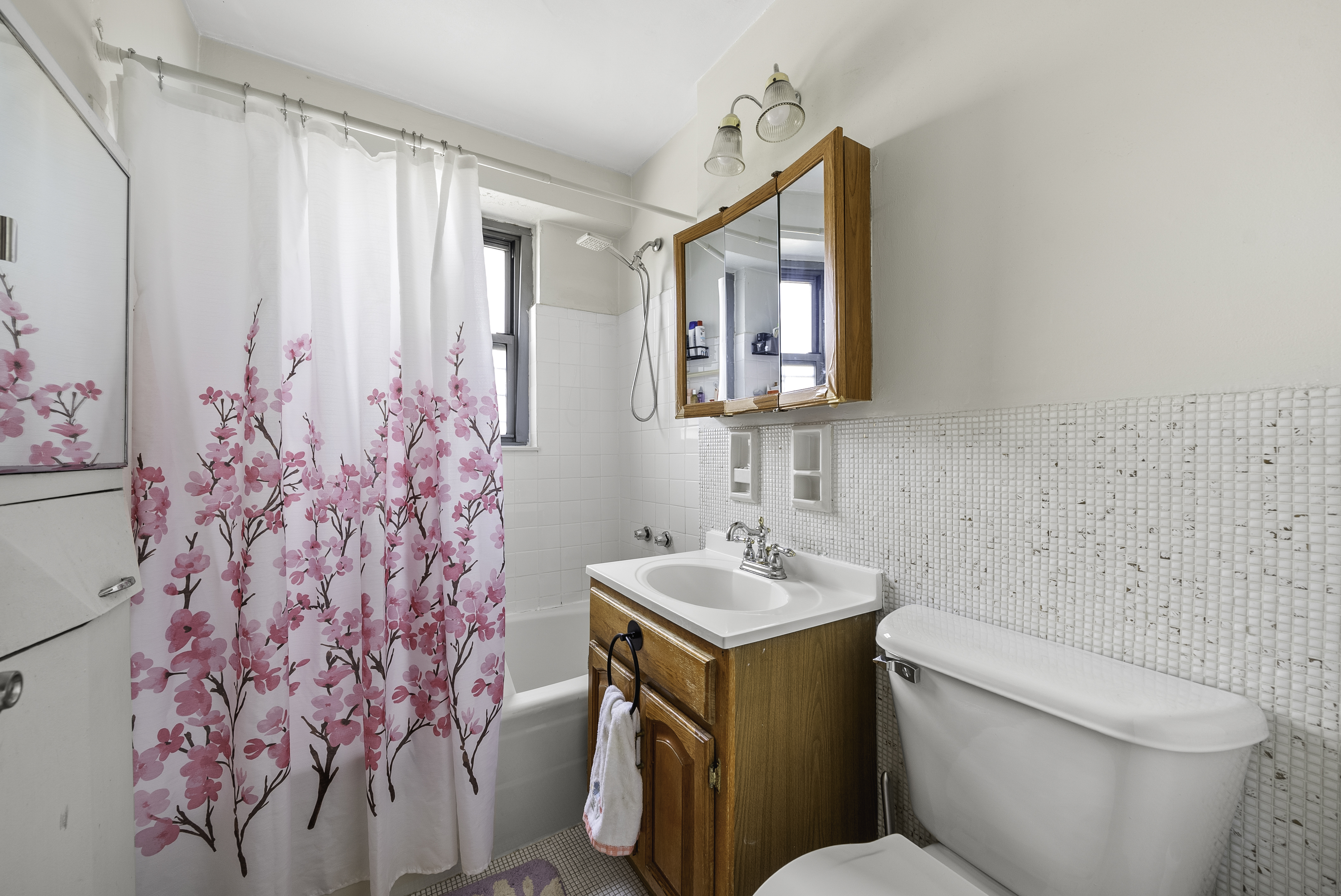 1020 Grand Concourse, Unit 5G Bronx, NY 10451 - Photo 5 of 11 a bathroom with a sink toilet and shower