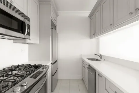 a kitchen with stainless steel appliances a sink and a stove