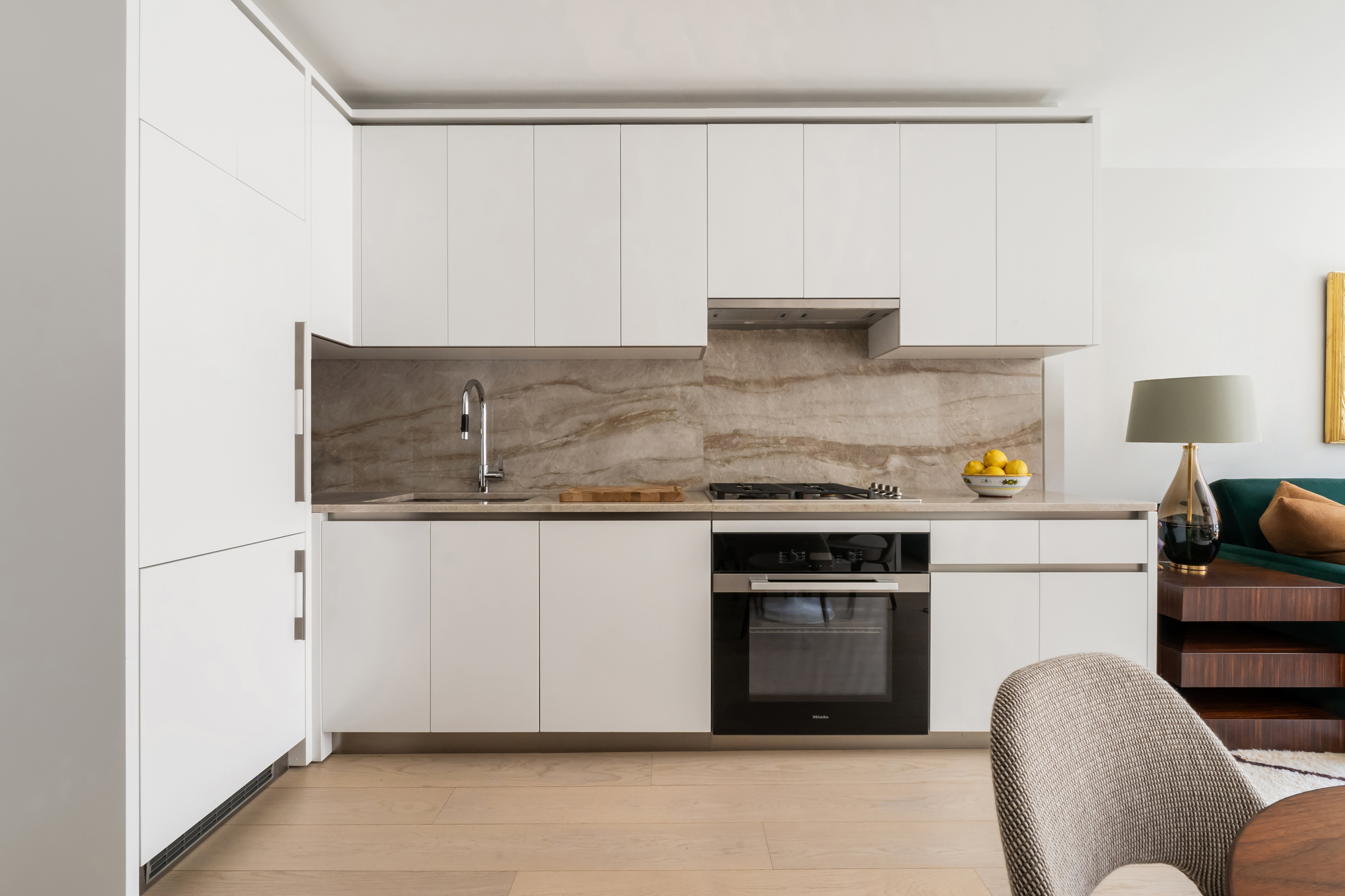 450 Washington Street, Unit 517 Manhattan, NY 10013 - Photo 2 of 11 a kitchen with stainless steel appliances granite countertop a stove and a refrigerator