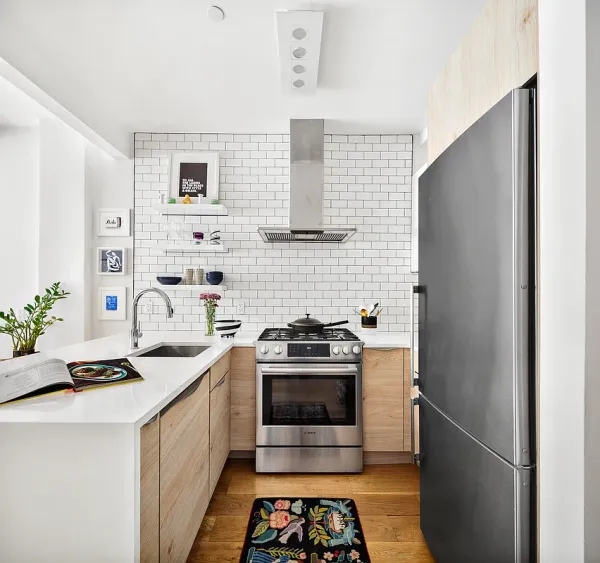 a kitchen with stainless steel appliances a stove a sink and a refrigerator