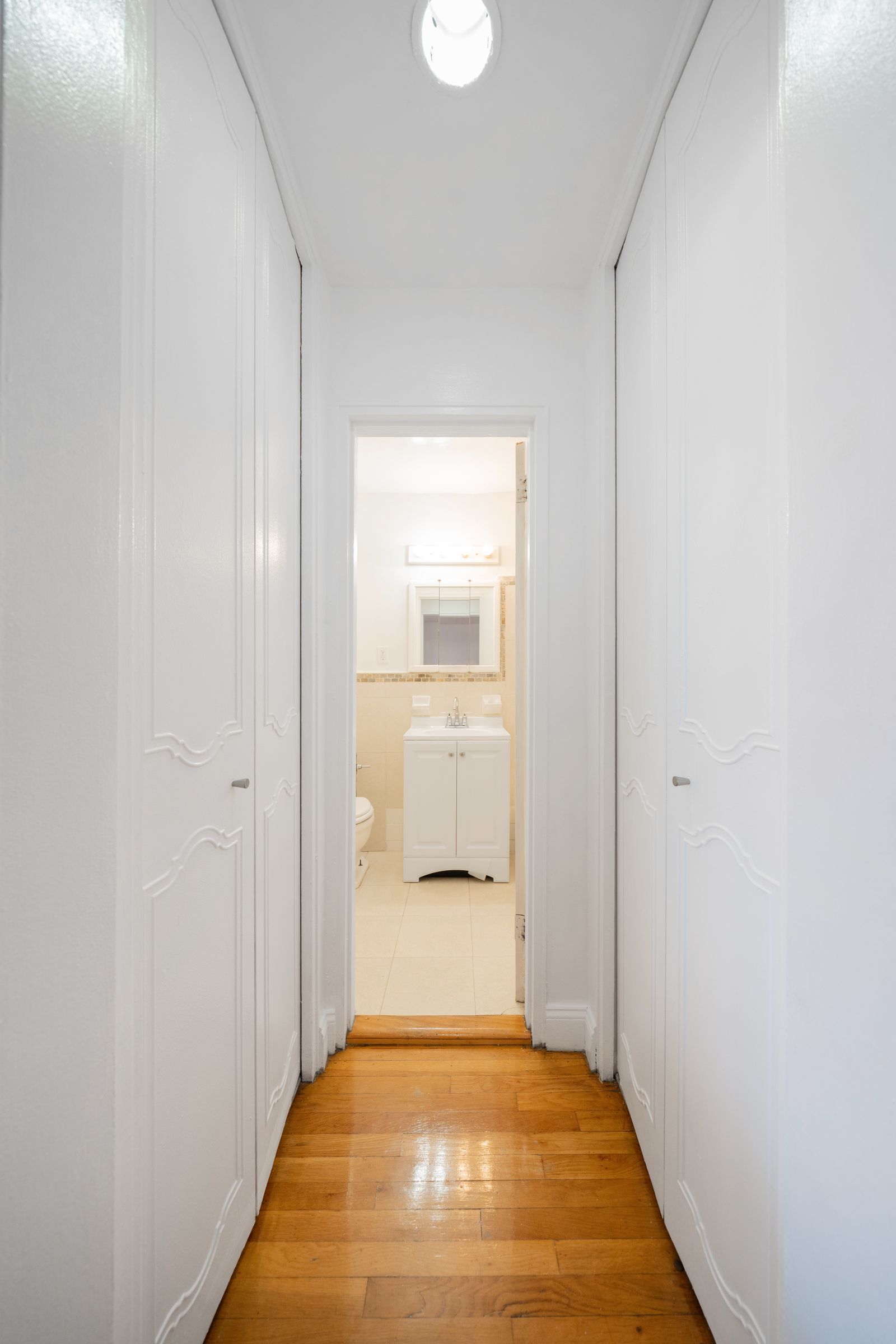 1270 East 51st Street, Unit 6M Brooklyn, NY 11234 - Photo 7 of 12 a view of a hallway with a wooden floor and a door