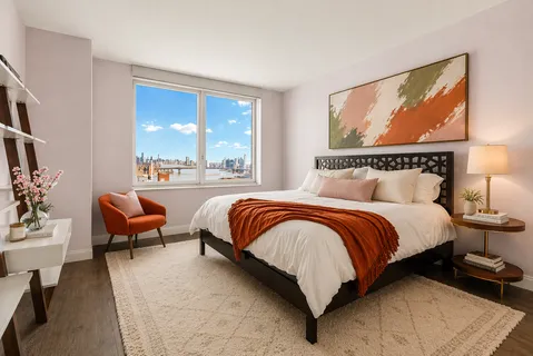 a bedroom with a bed and glass windows