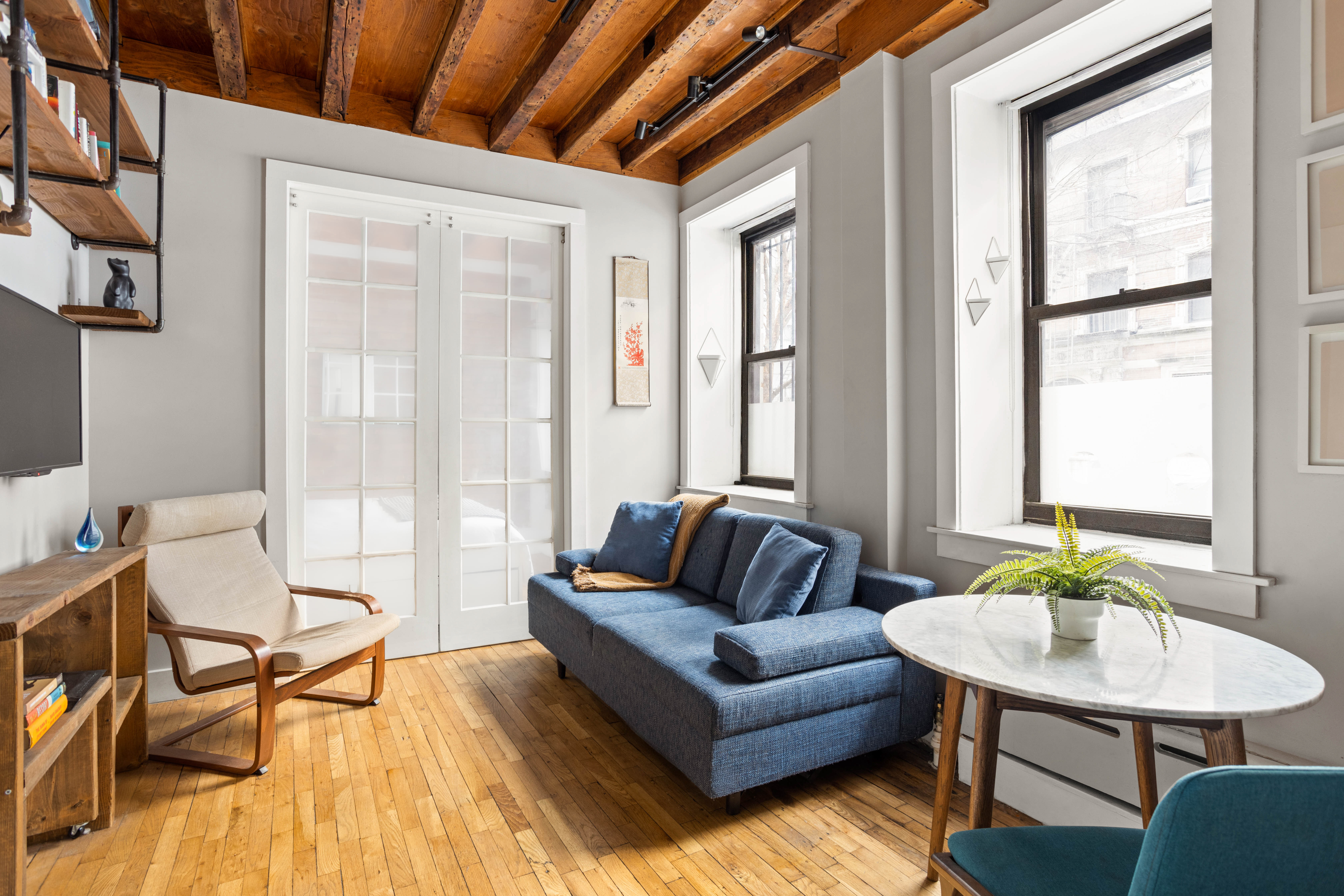4 West 101st Street, Unit 5 Manhattan, NY 10025 - Photo 5 of 9 a living room with furniture and a large window